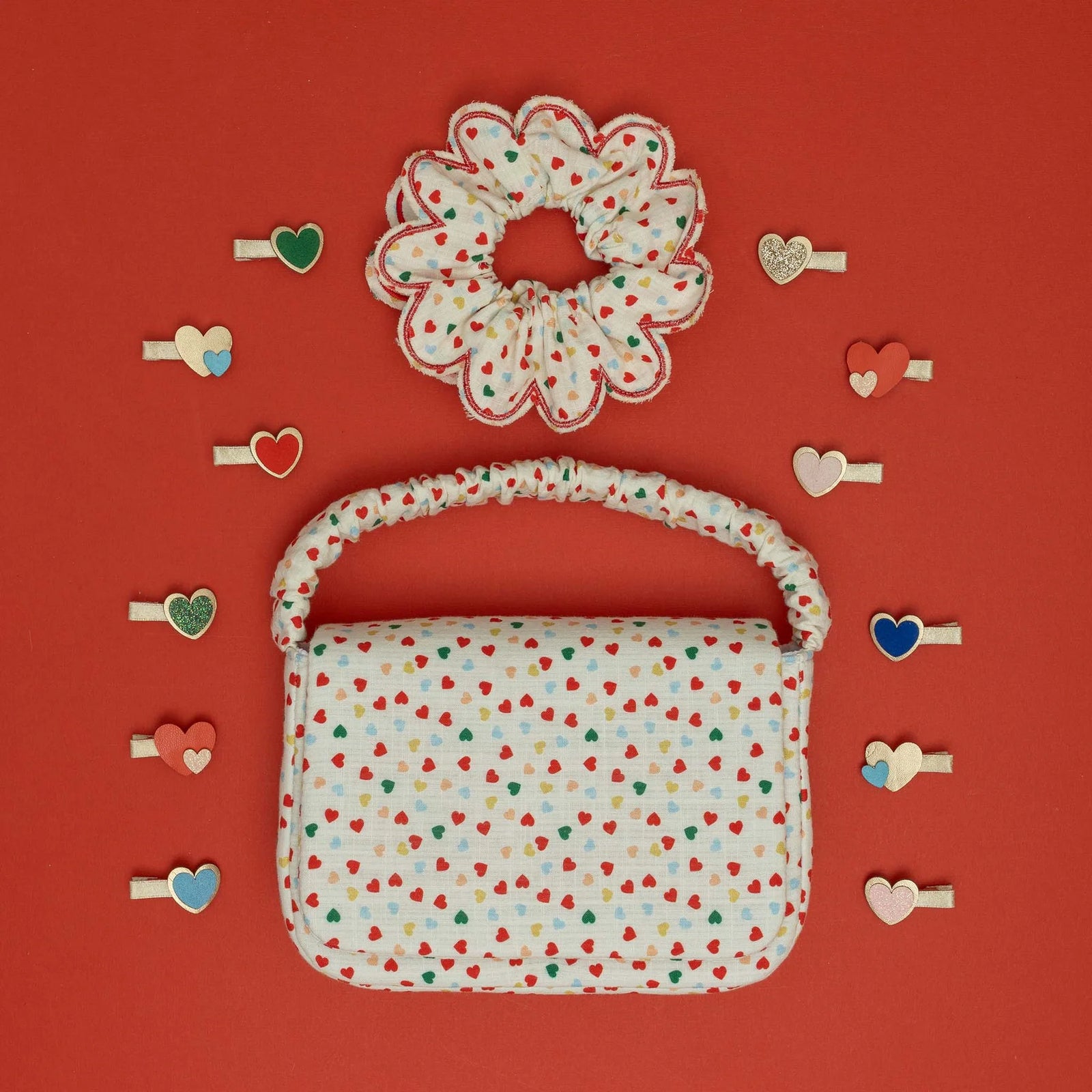 Small handbag with colorful heart pattern on a white background