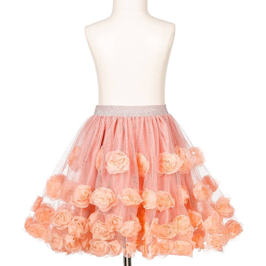 Peach-colored tulle skirt with floral details on a mannequin against a white background