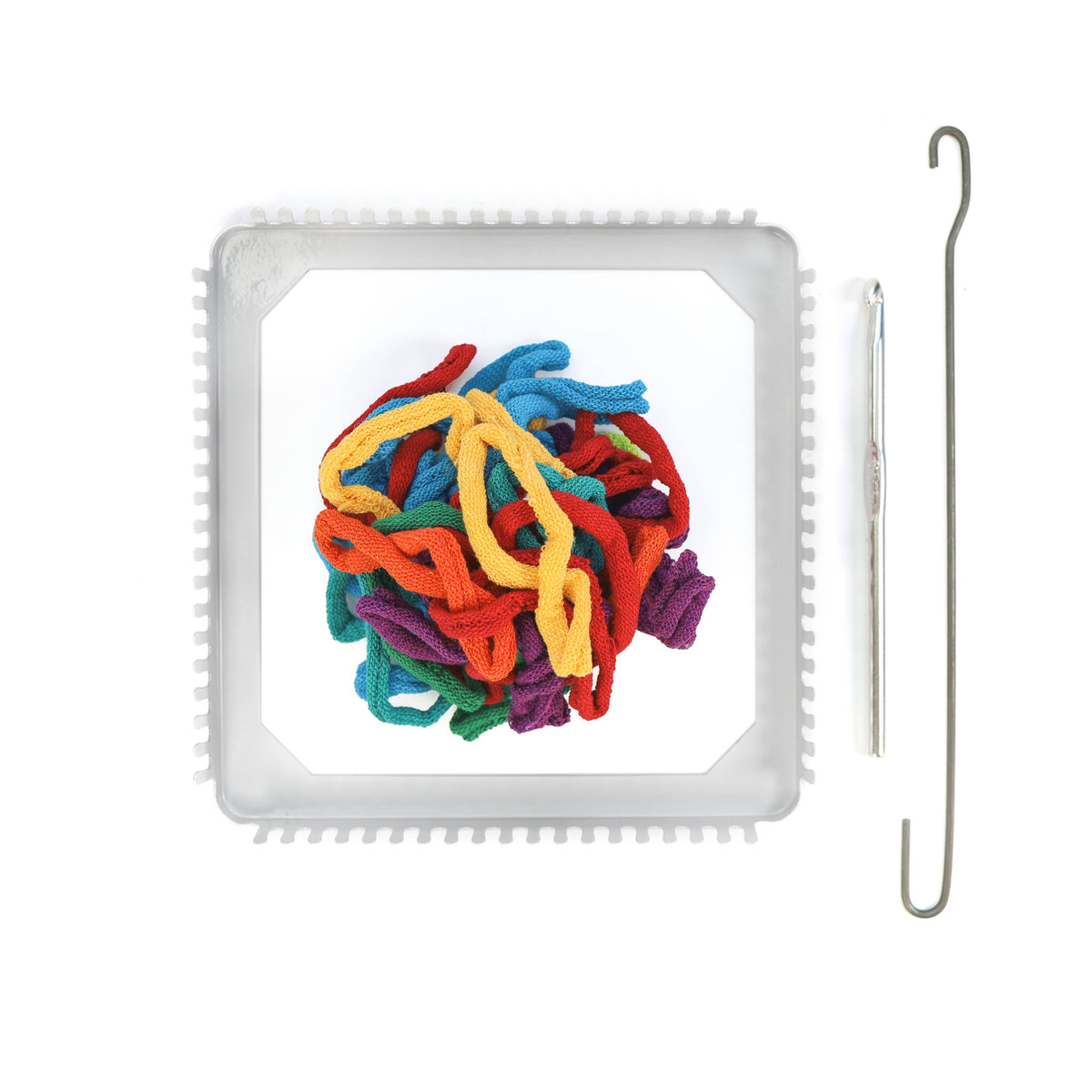 Colorful yarn on a metal loom with a crochet hook on a white background