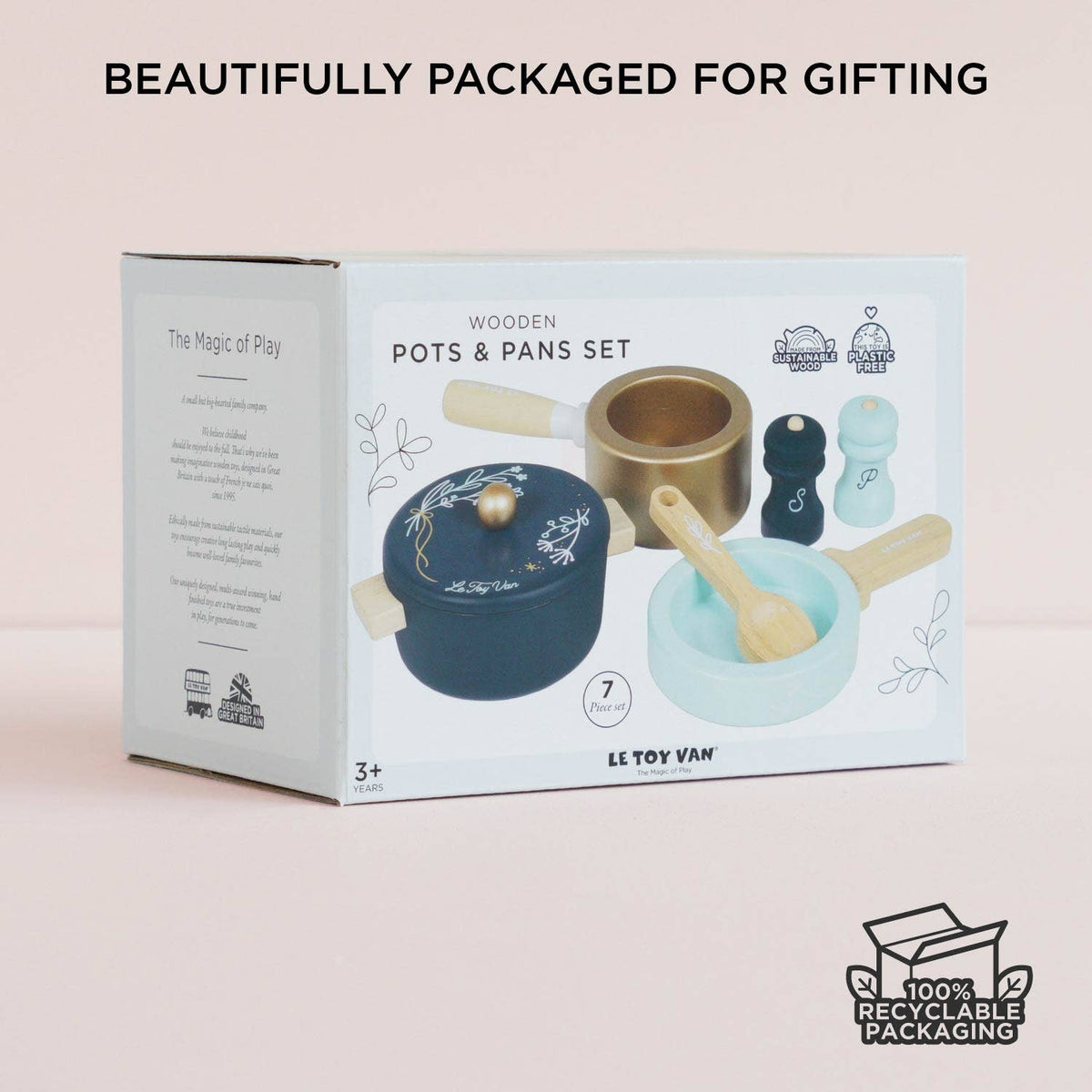 LE TOY VAN wooden pots and pans set in its original white gift box, displayed on a soft pink background with the text 'BEAUTIFULLY PACKAGED FOR GIFTING' at the top.