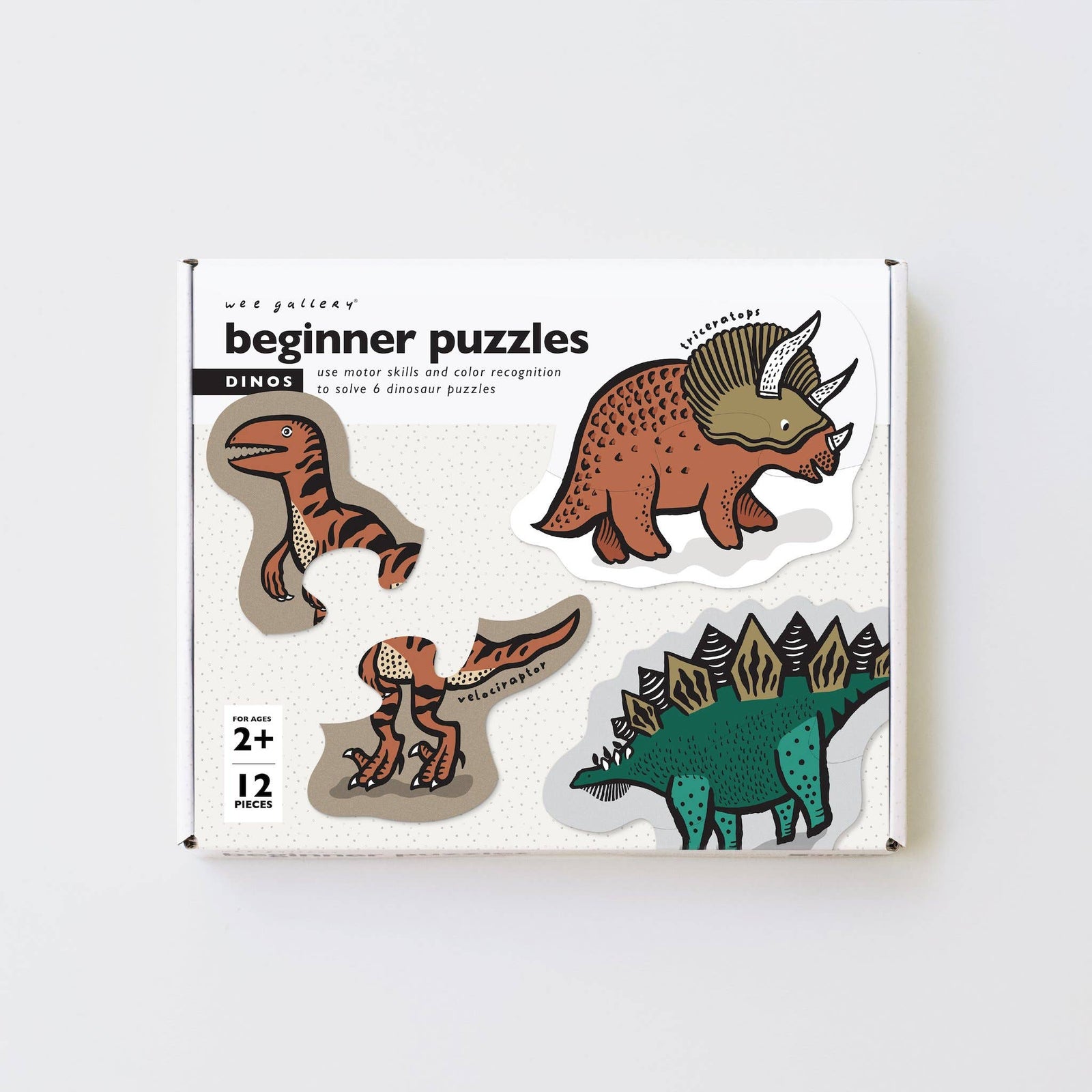 Box of dinosaur puzzles for beginners on a white background