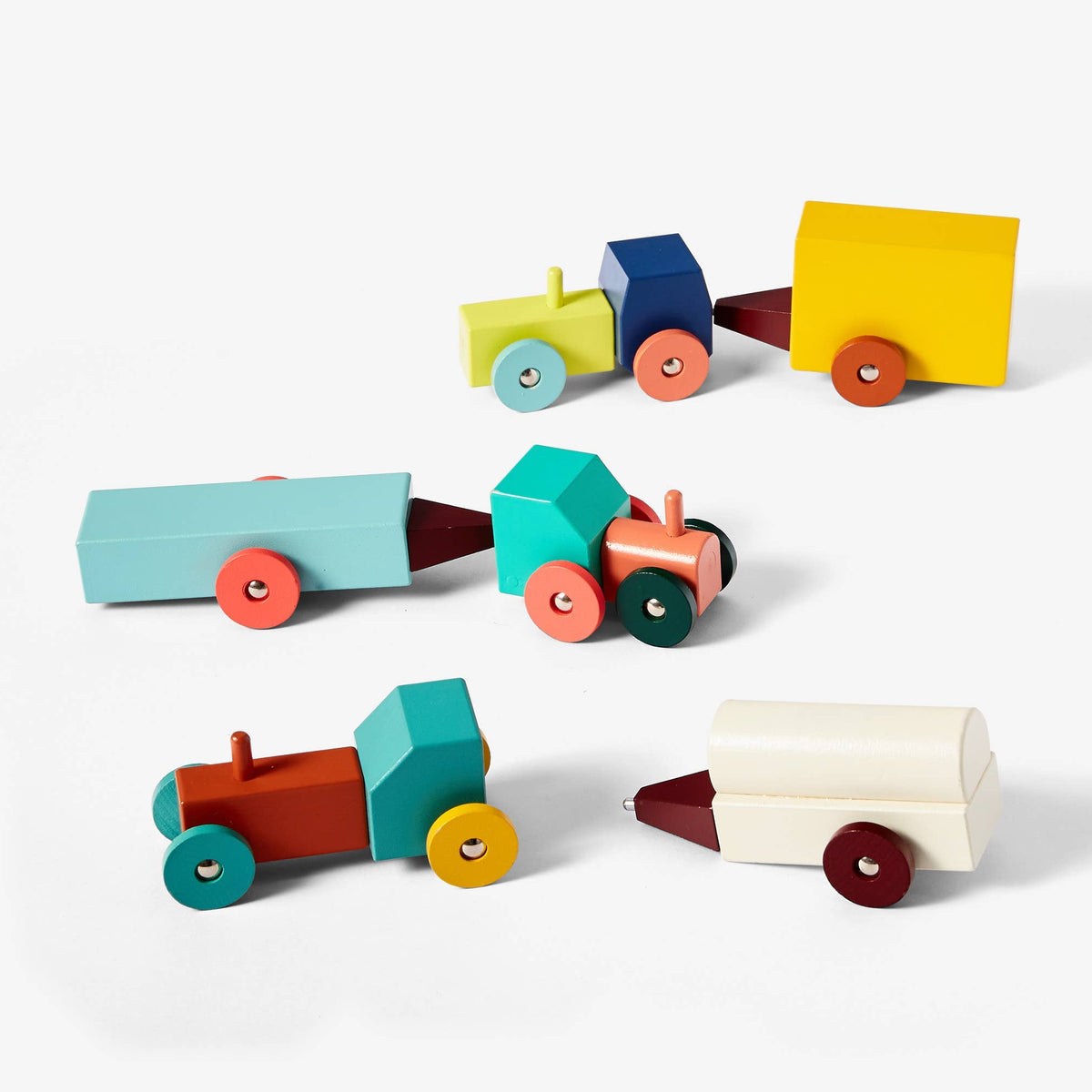 Set of colorful wooden toy cars on a white background
