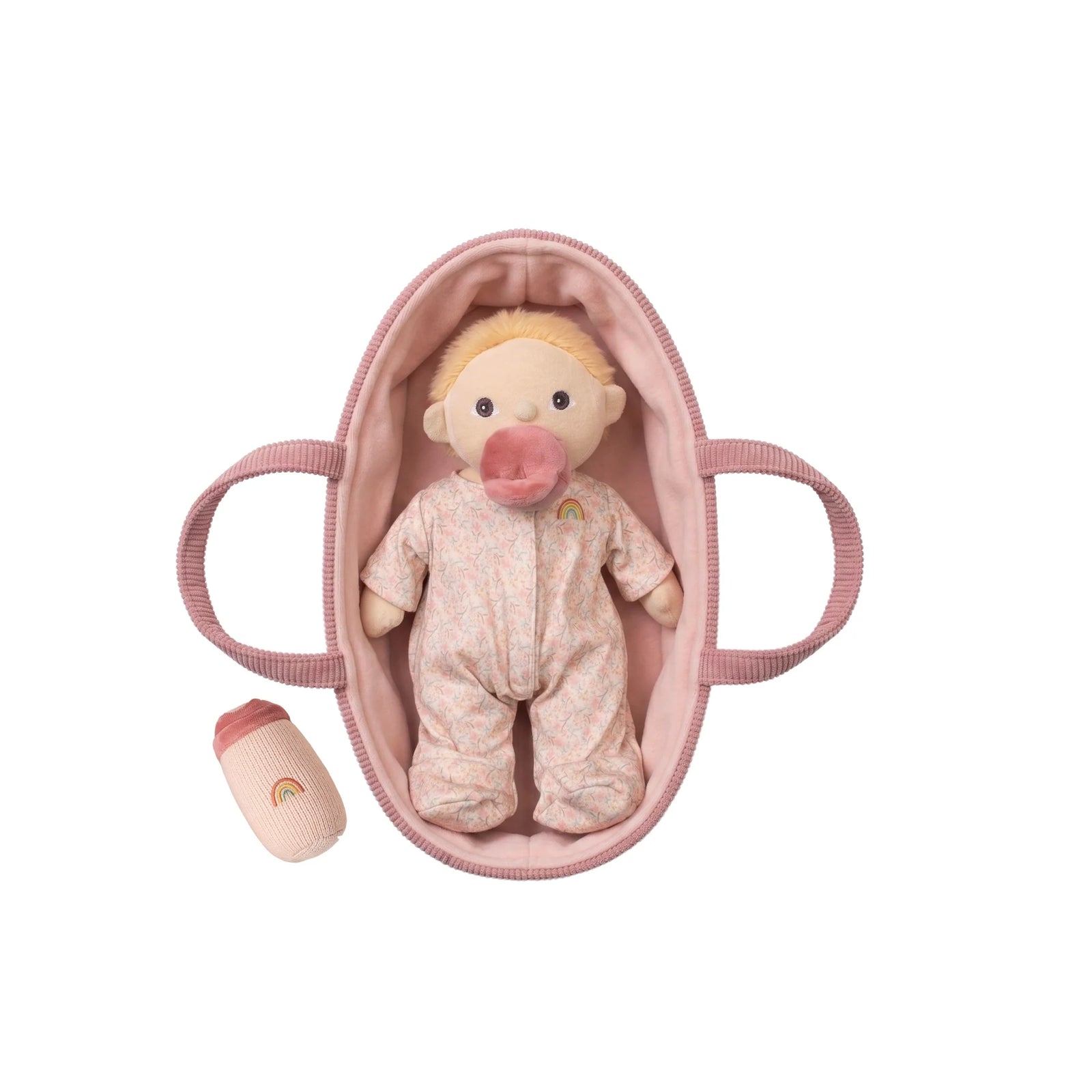 Baby doll in a pink crib with a pacifier on a white background
