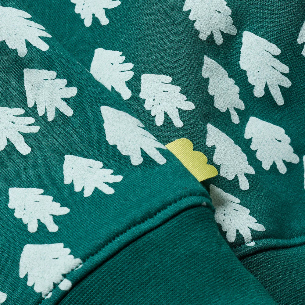 Green fabric with white tree pattern and yellow accent