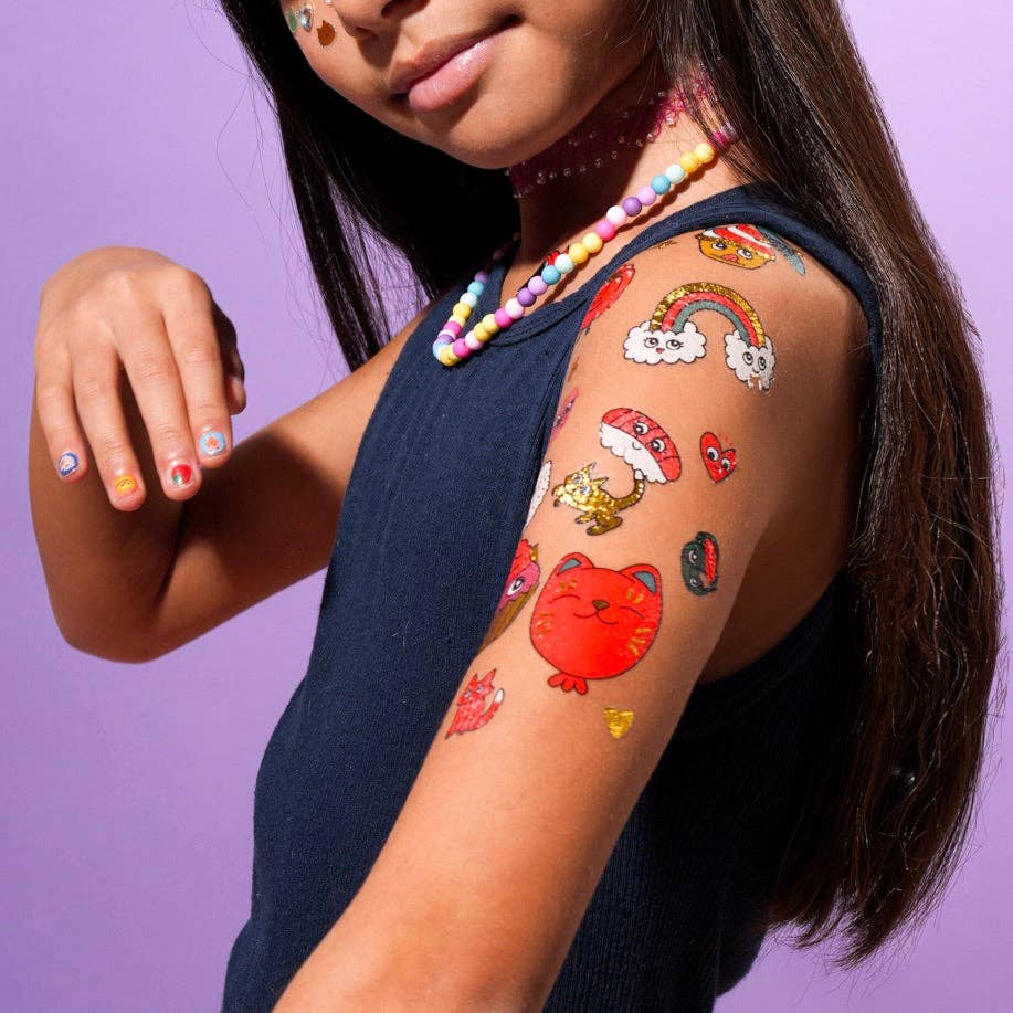 Girl with colorful temporary tattoos on her arm against a purple background
