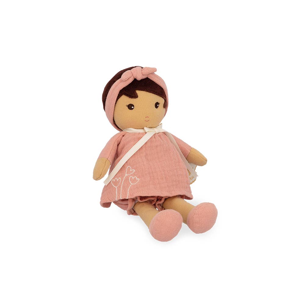 Stuffed doll with pink outfit and headband on a white background