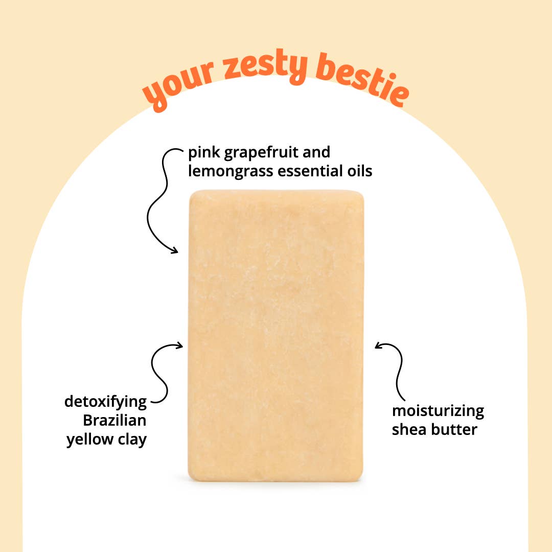 Sunniemade grapefruit soap bar and packaging on a yellow background with a sliced grapefruit.