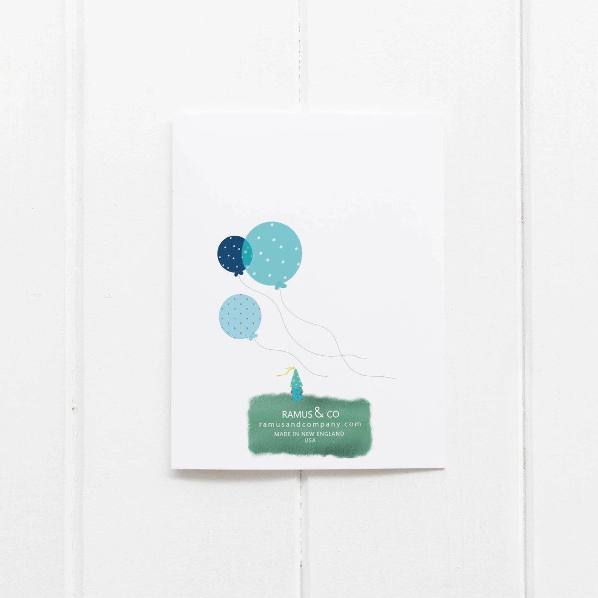 Card with blue balloons and a brand name on a white background
