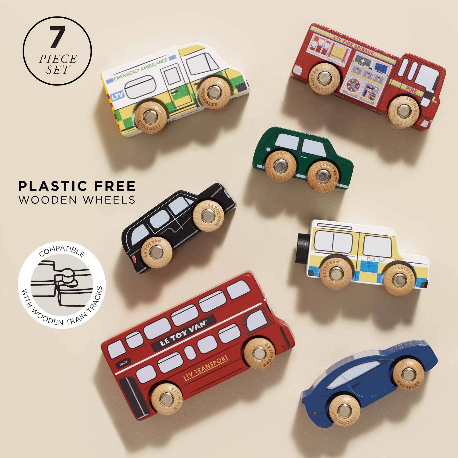Set of colorful wooden toy vehicles including a bus, cars, and an ambulance on a white background.