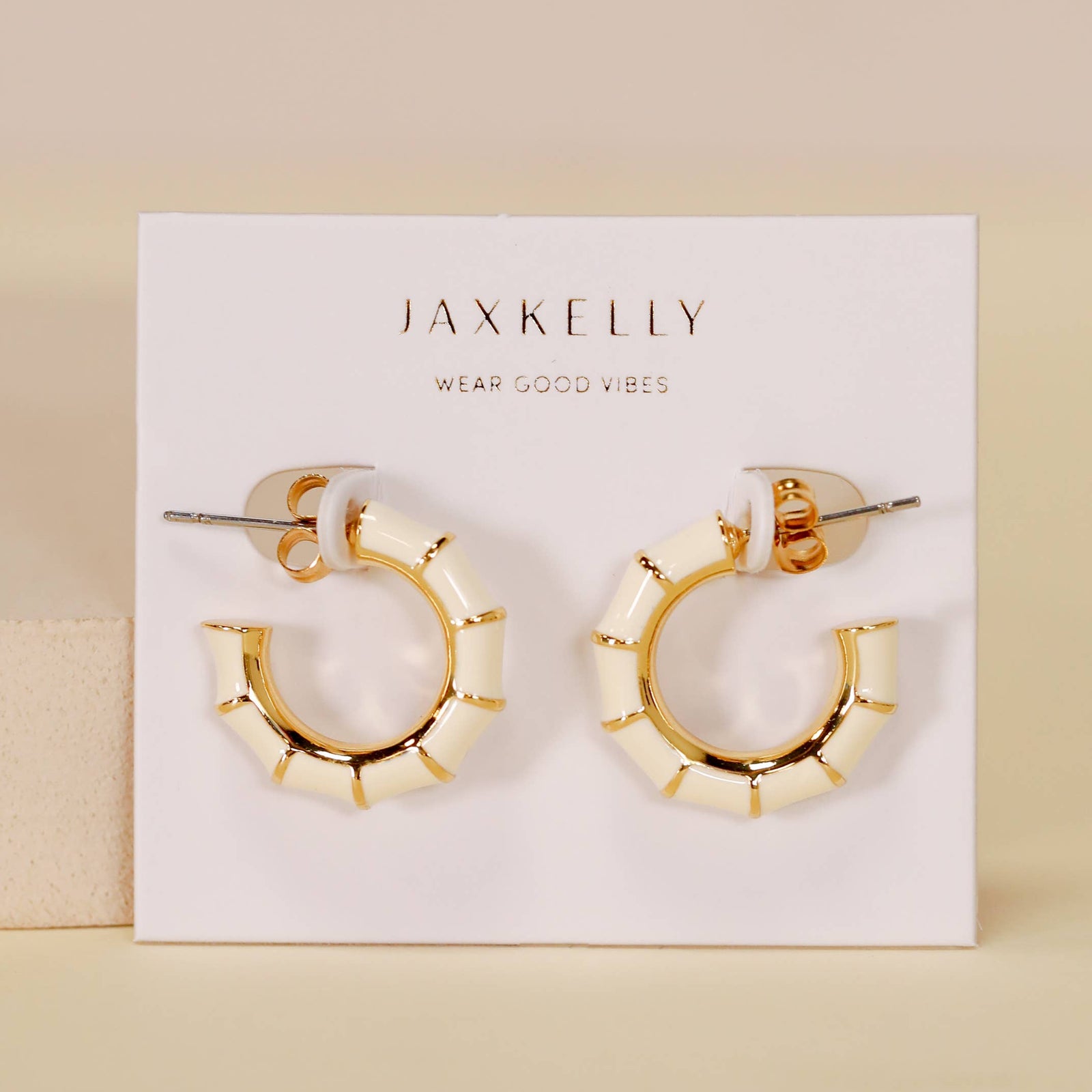 Gold hoop earrings on a JaxKelly branded card with a beige background