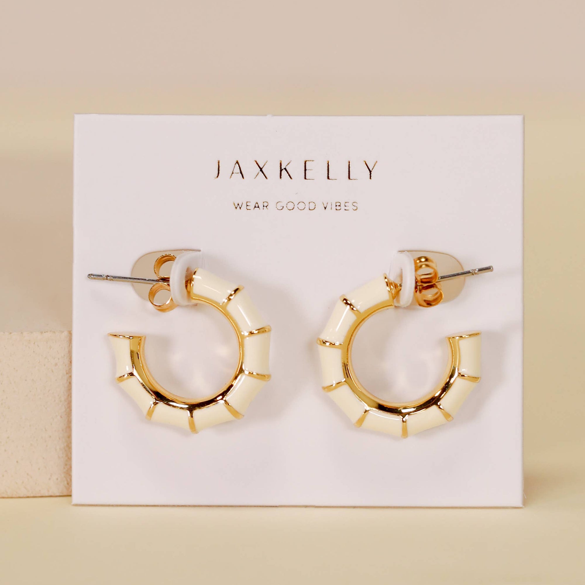 Gold hoop earrings on a JaxKelly branded card with a beige background