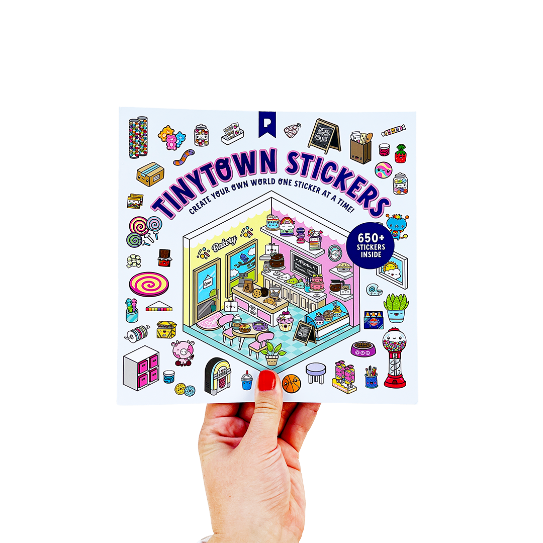 Hand holding a sticker book titled 'Tinytown Stickers' with colorful illustrations on a white background.