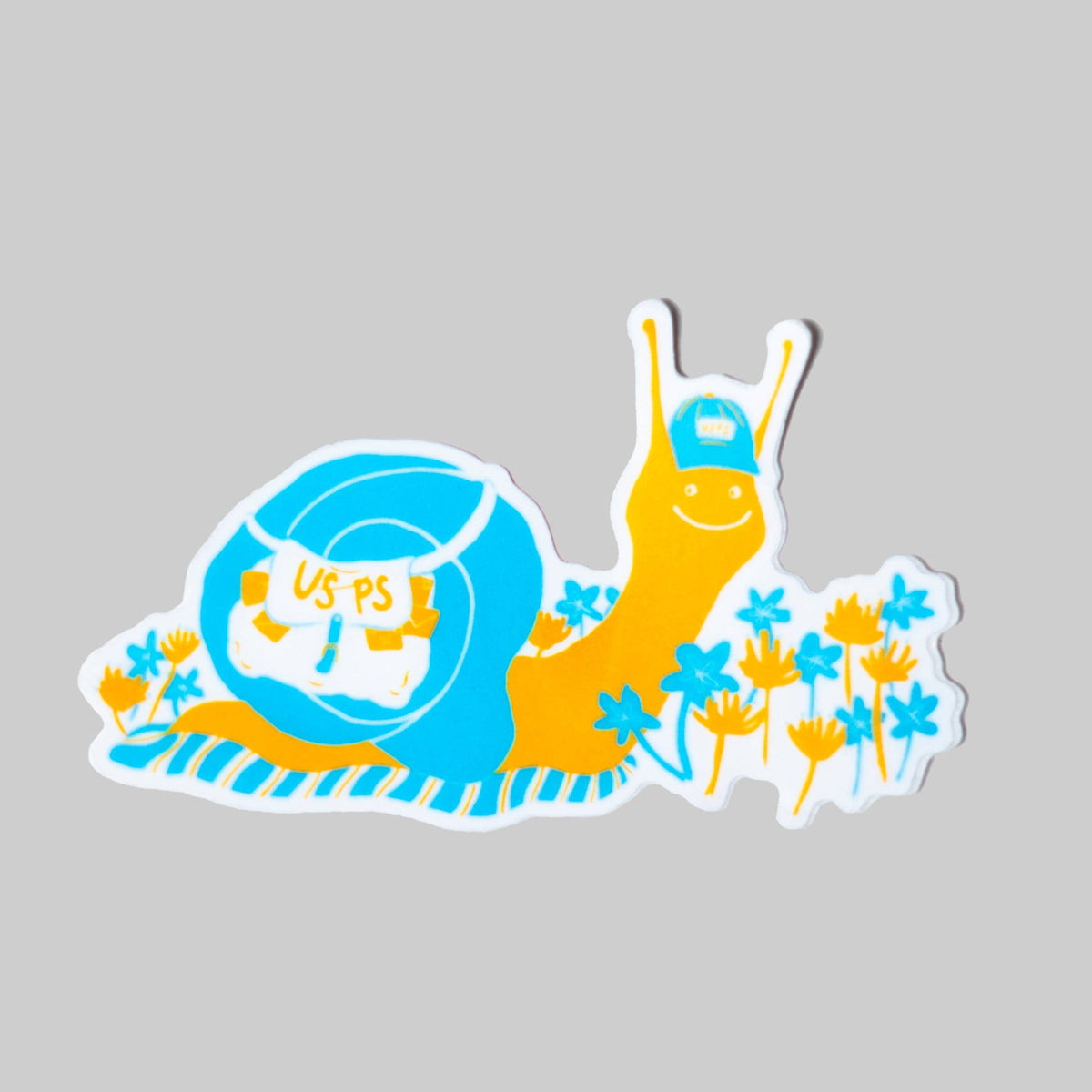 A die-cut sticker featuring a cartoon snail with a blue shell and yellow body, wearing a blue cap and surrounded by small blue flowers, shown on a plain light gray background.
