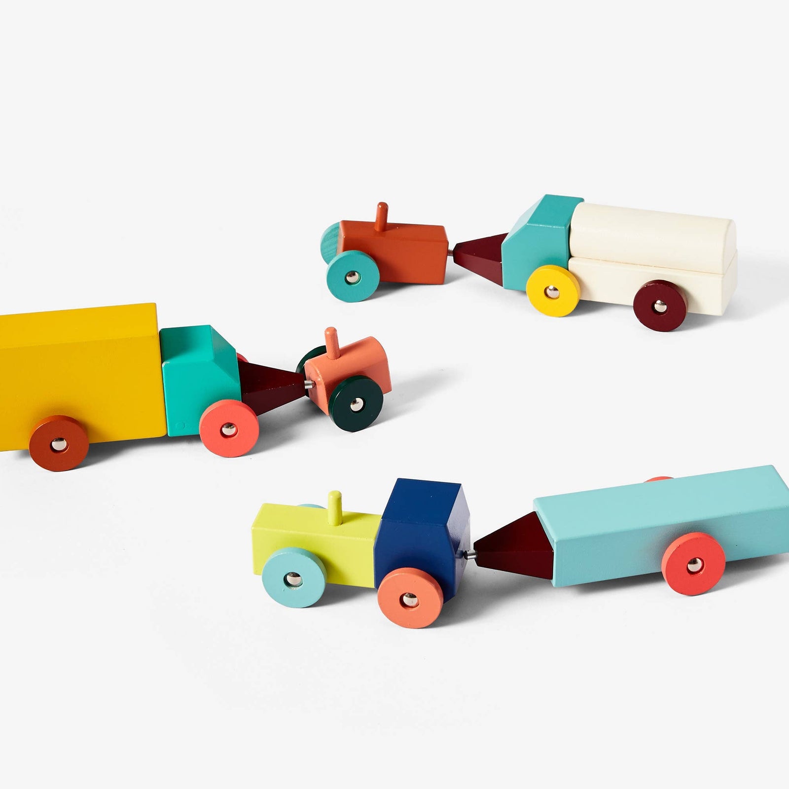 Set of colorful wooden toy trucks on a white background