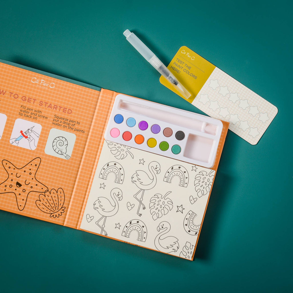 Coloring book with watercolor paint set and brush on a teal background