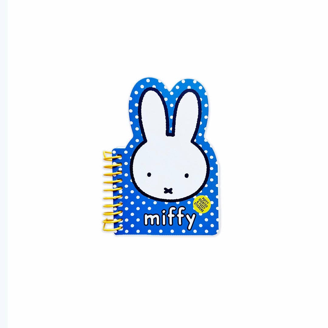 Notebook with a cartoon character on a blue polka dot cover against a white background