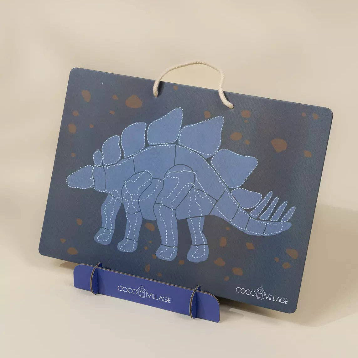 Blue dinosaur skeleton design on a card with 'Coco Village' branding.