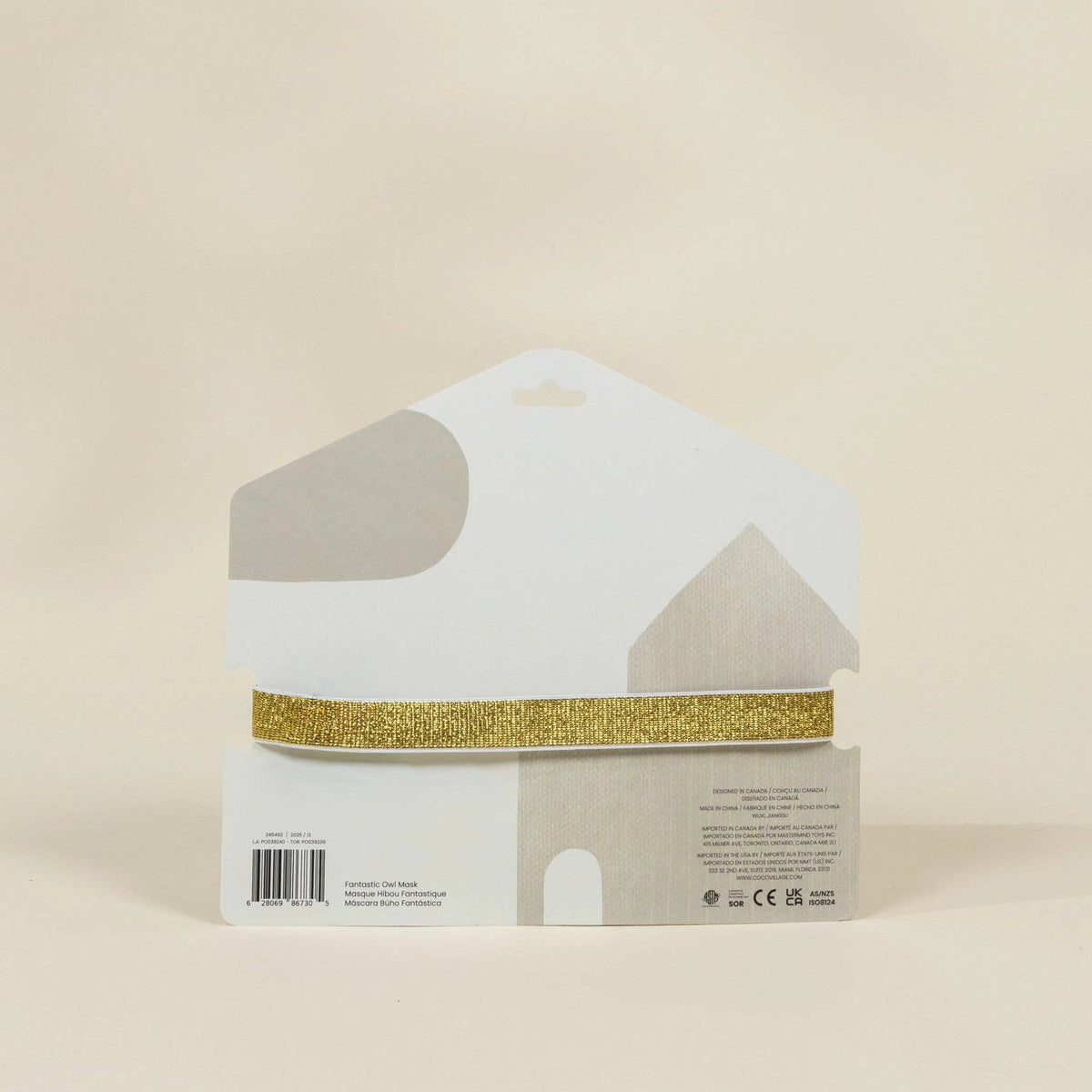 Product packaging with gold ribbon on a beige background