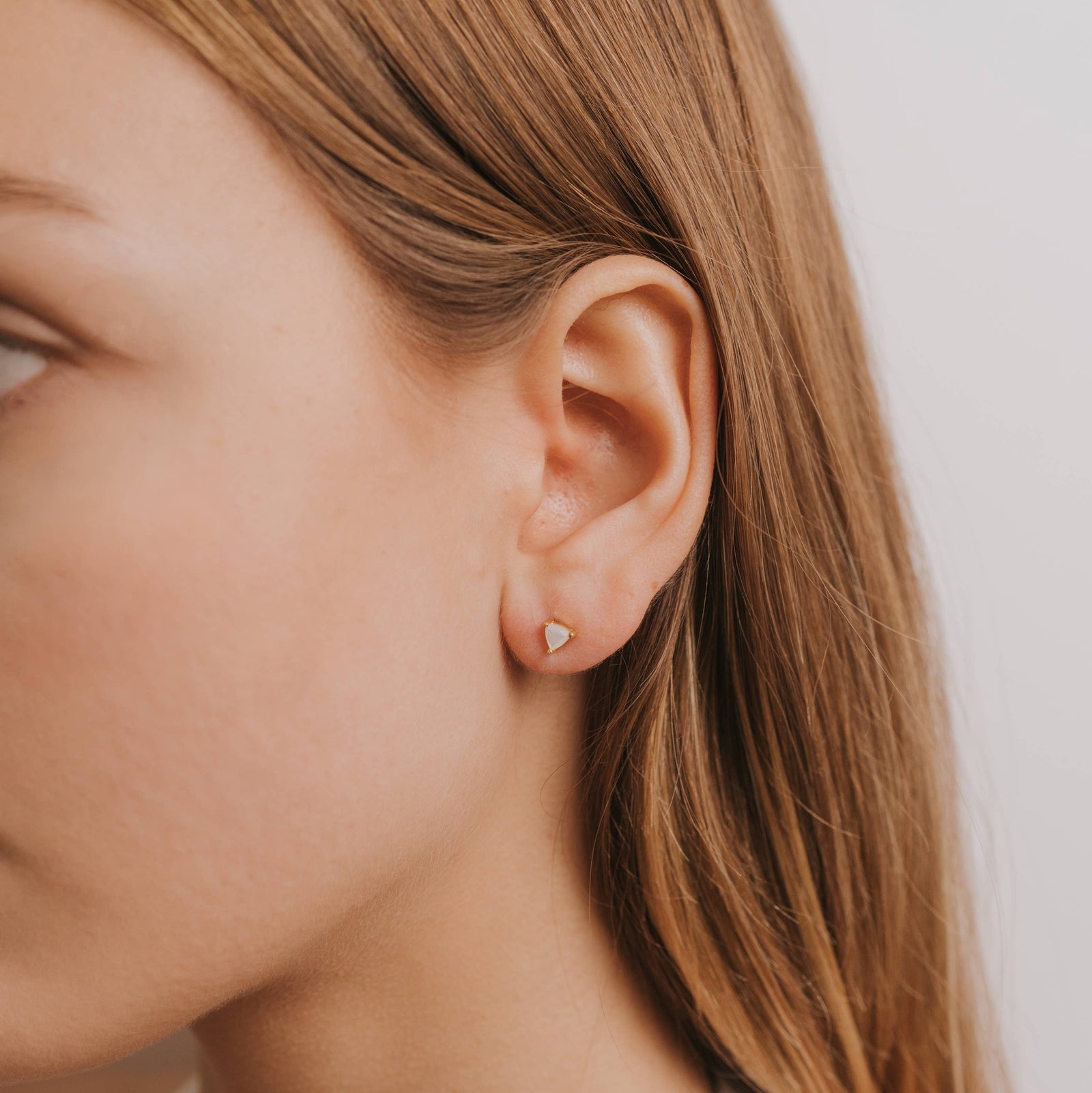 Pair of triangle-shaped earrings on a light gray background
