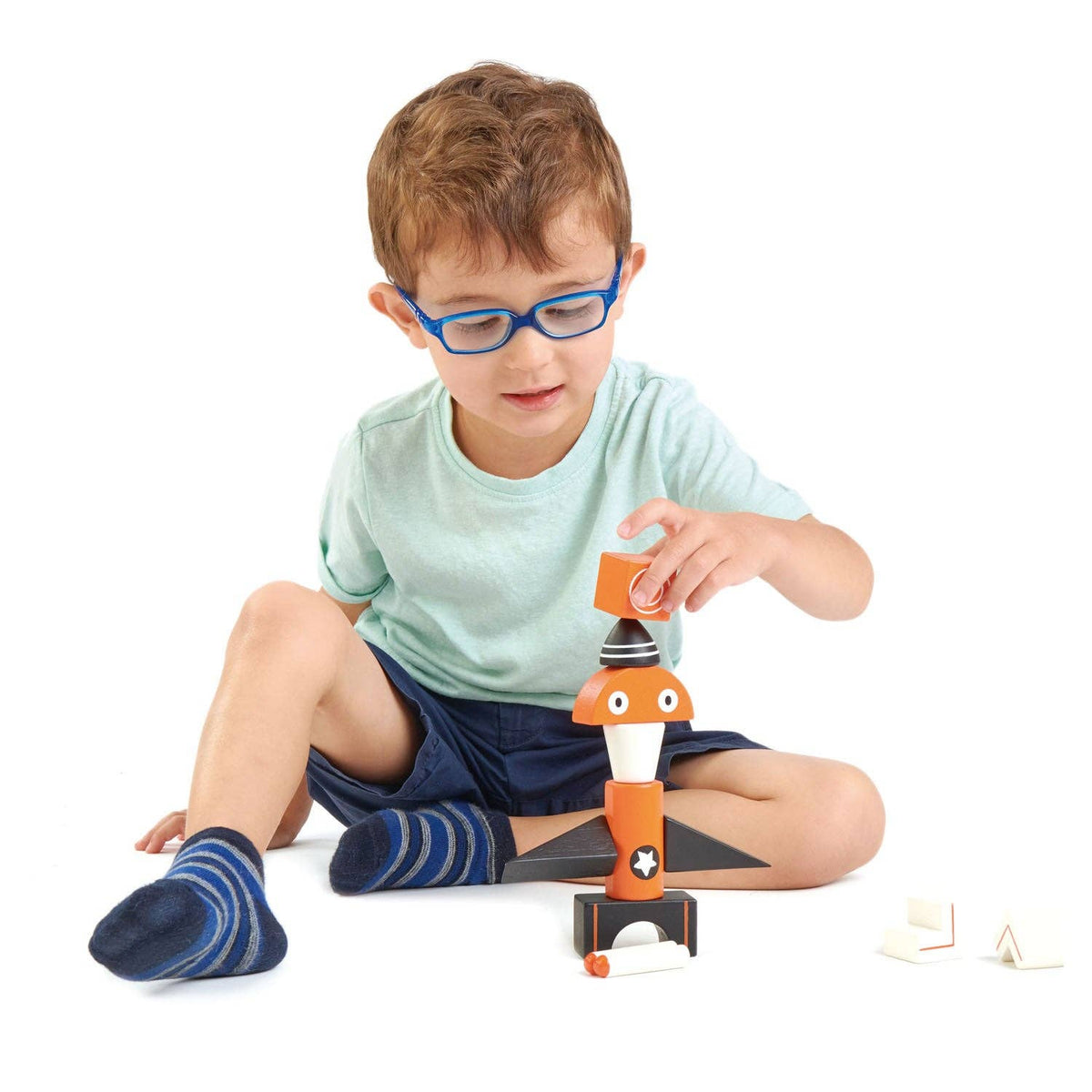 Child playing with a toy figure on a white background