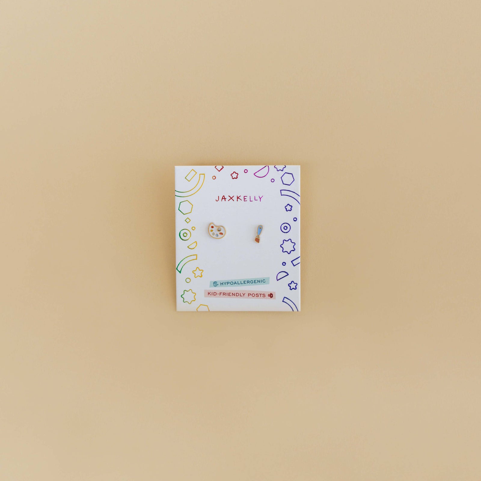 Jewelry card with earrings on a beige background