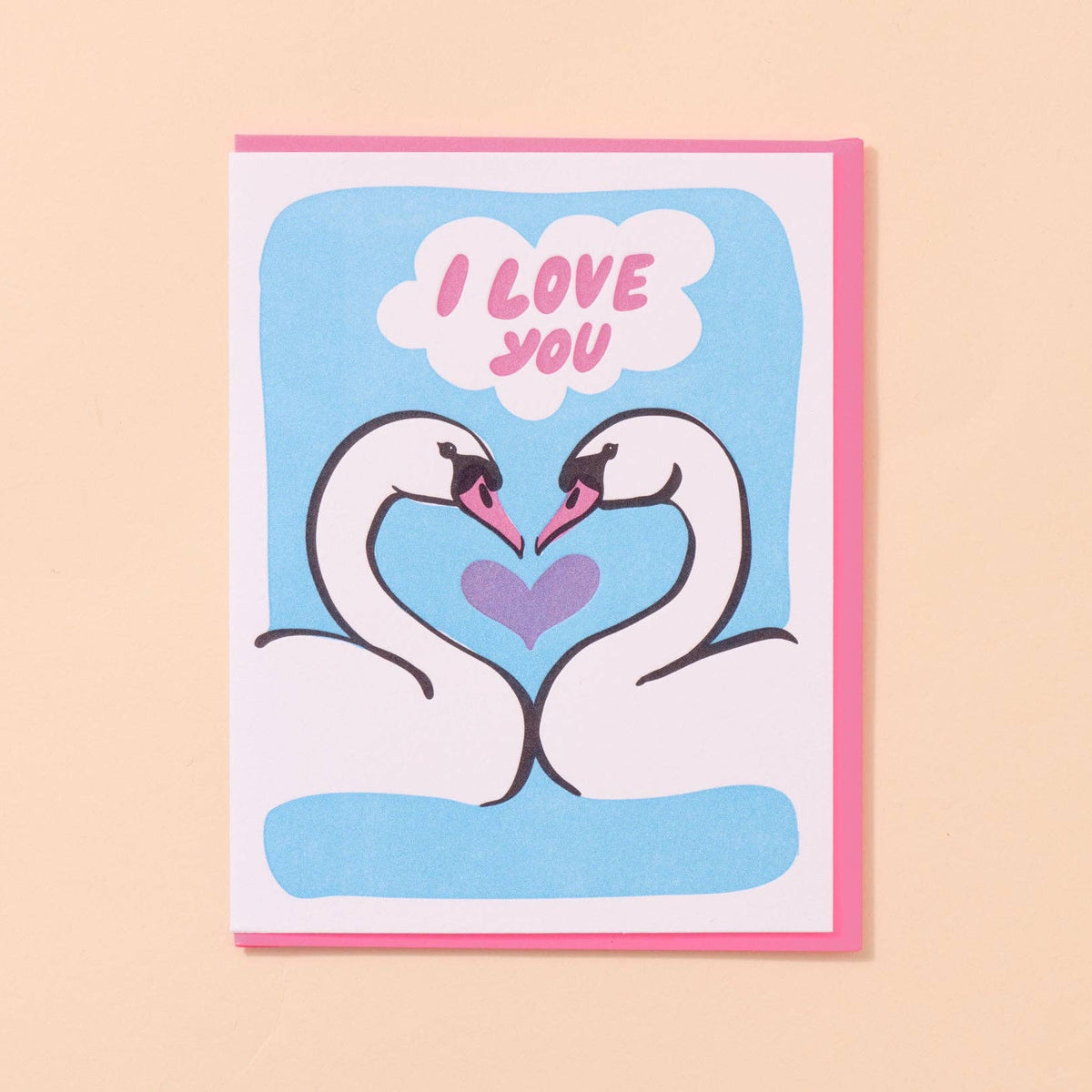 Card with two swans forming a heart and 'I love you' text on a beige background