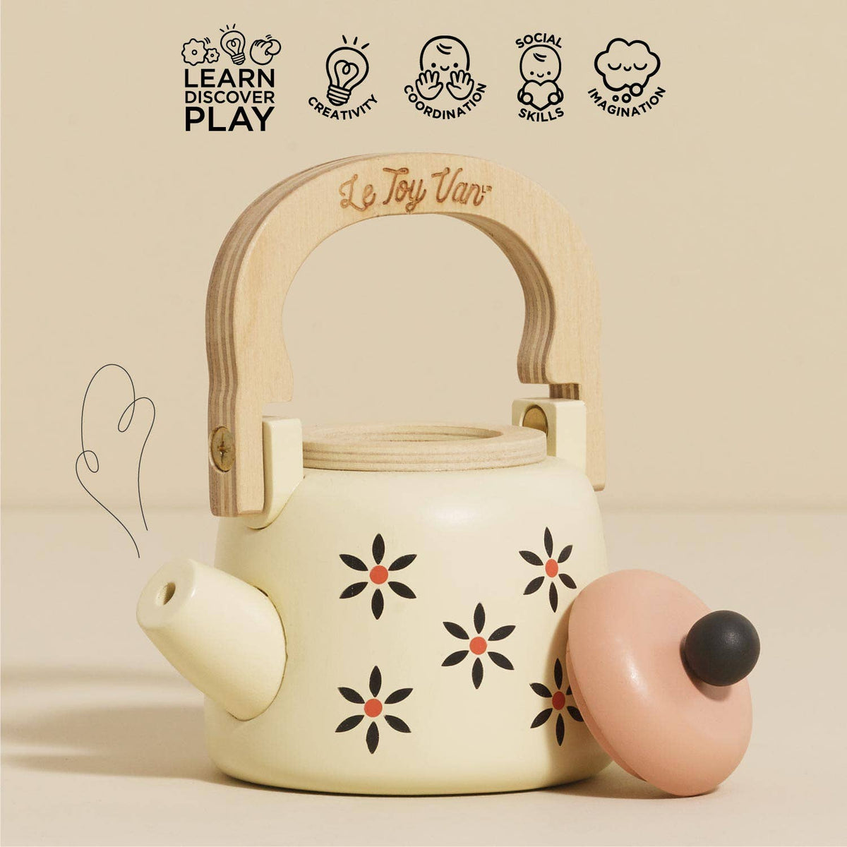 Children's toy teapot with wooden handle and floral design on a beige background, featuring Le Toy Van branding.