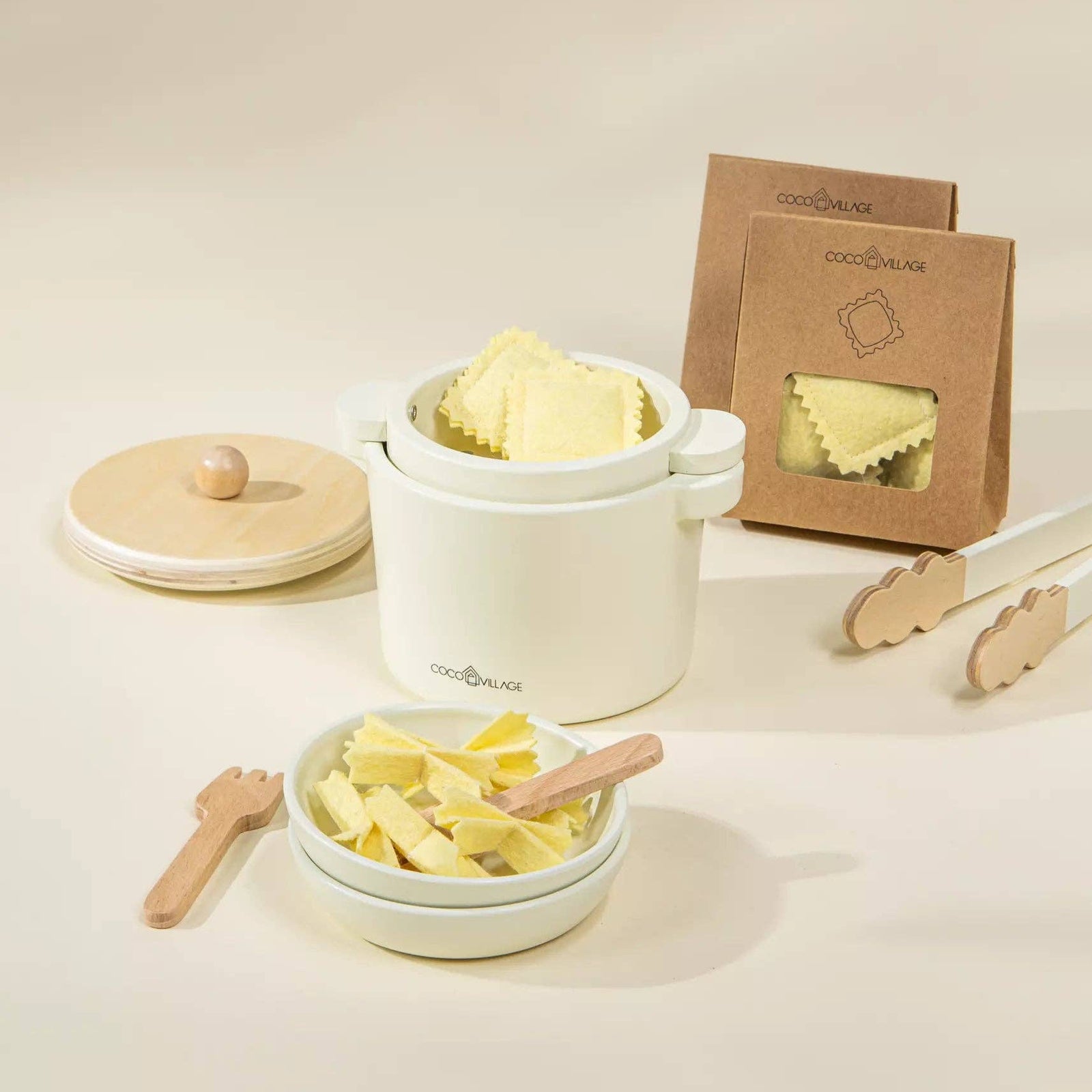 Set of white containers with pasta and wooden utensils on a light background