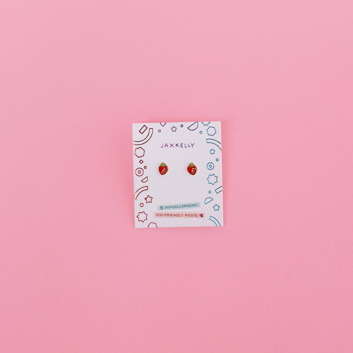 Card with earrings on a pink background