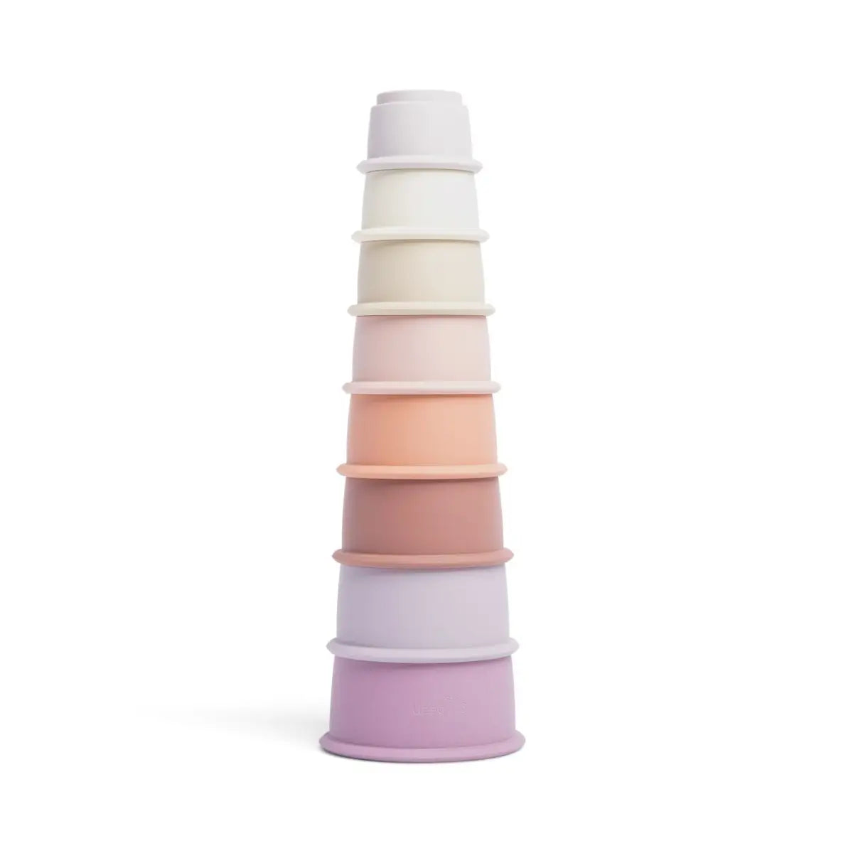 A set of stacking silicone cups in various pastel colors, with the topmost cup being white and the rest gradually getting lighter in color down to a purple base cup.