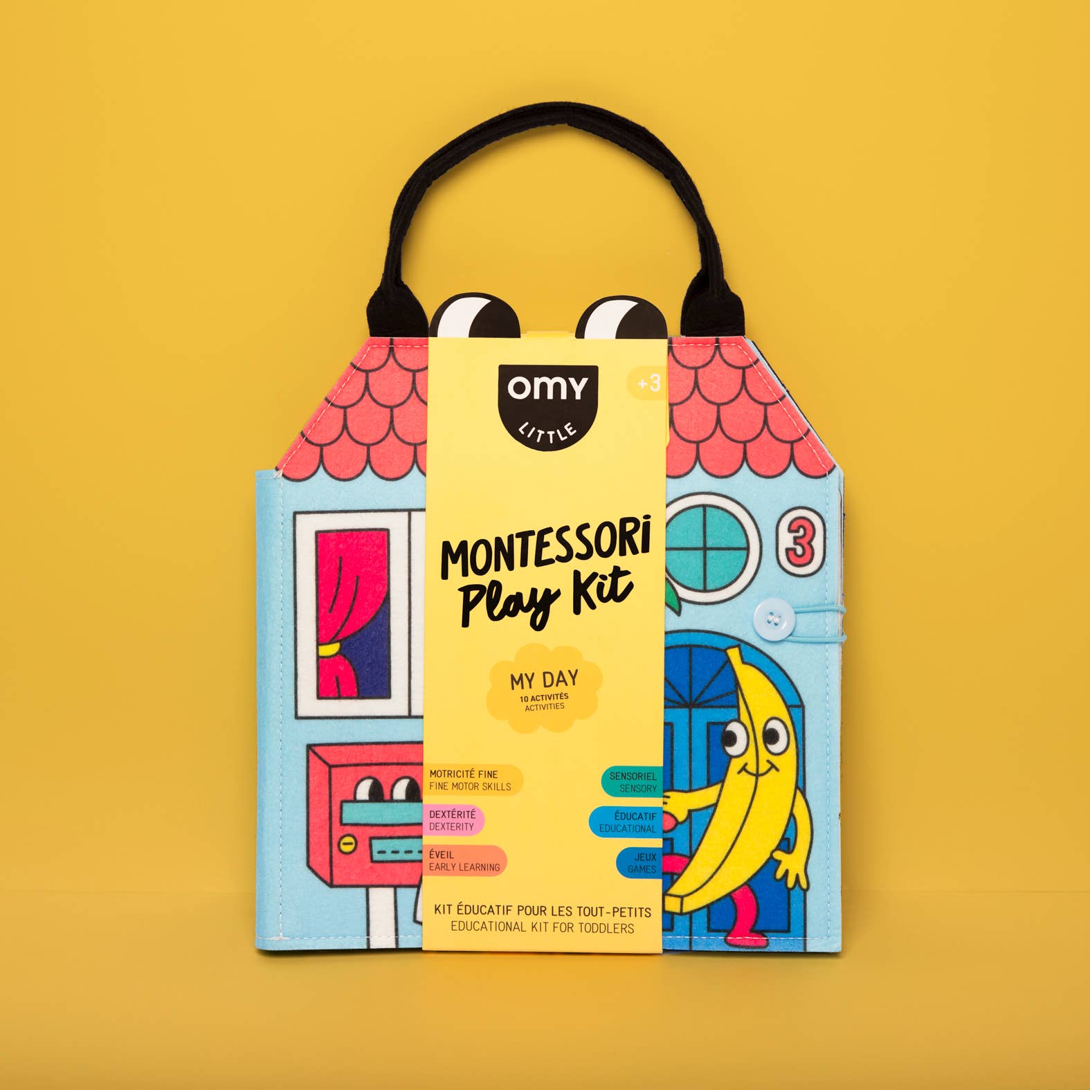 A colorful Montessori play kit bag with various activity cards and a yellow label that reads 'Montessori Play Kit - My Day'.