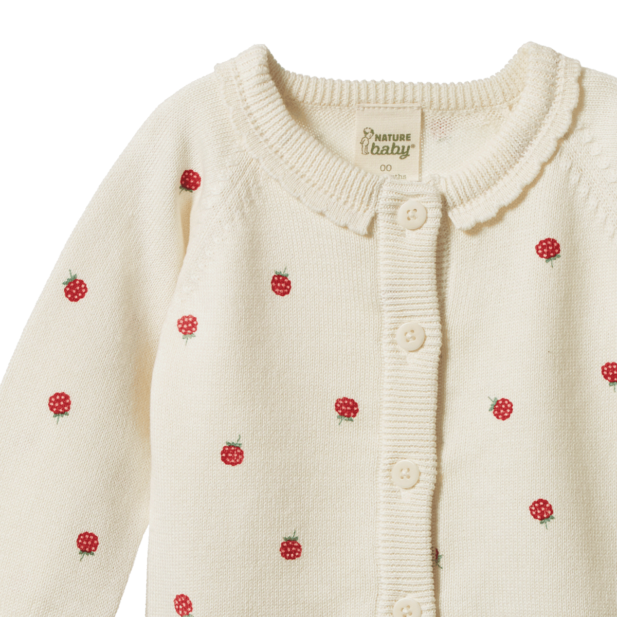Cream-colored cardigan with red berry patterns and 'Bamberg Baby' label on a white background