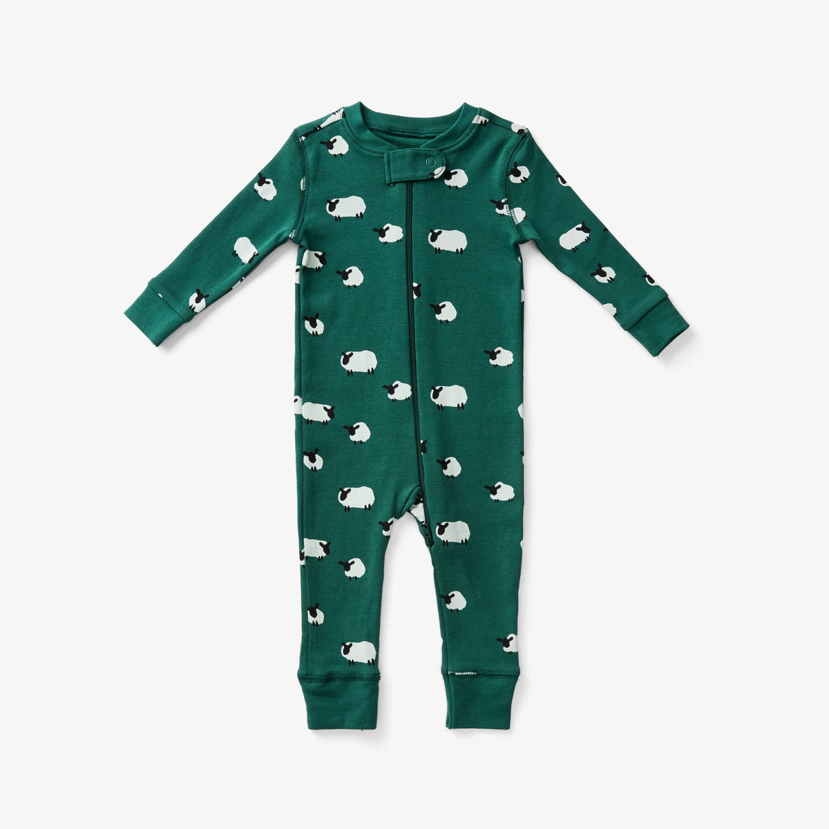 A long-sleeve baby pajama in dark green, featuring an all-over print of white sheep with black faces. The front has a zipper and ribbed cuffs and hem, shown flat on a light gray background.