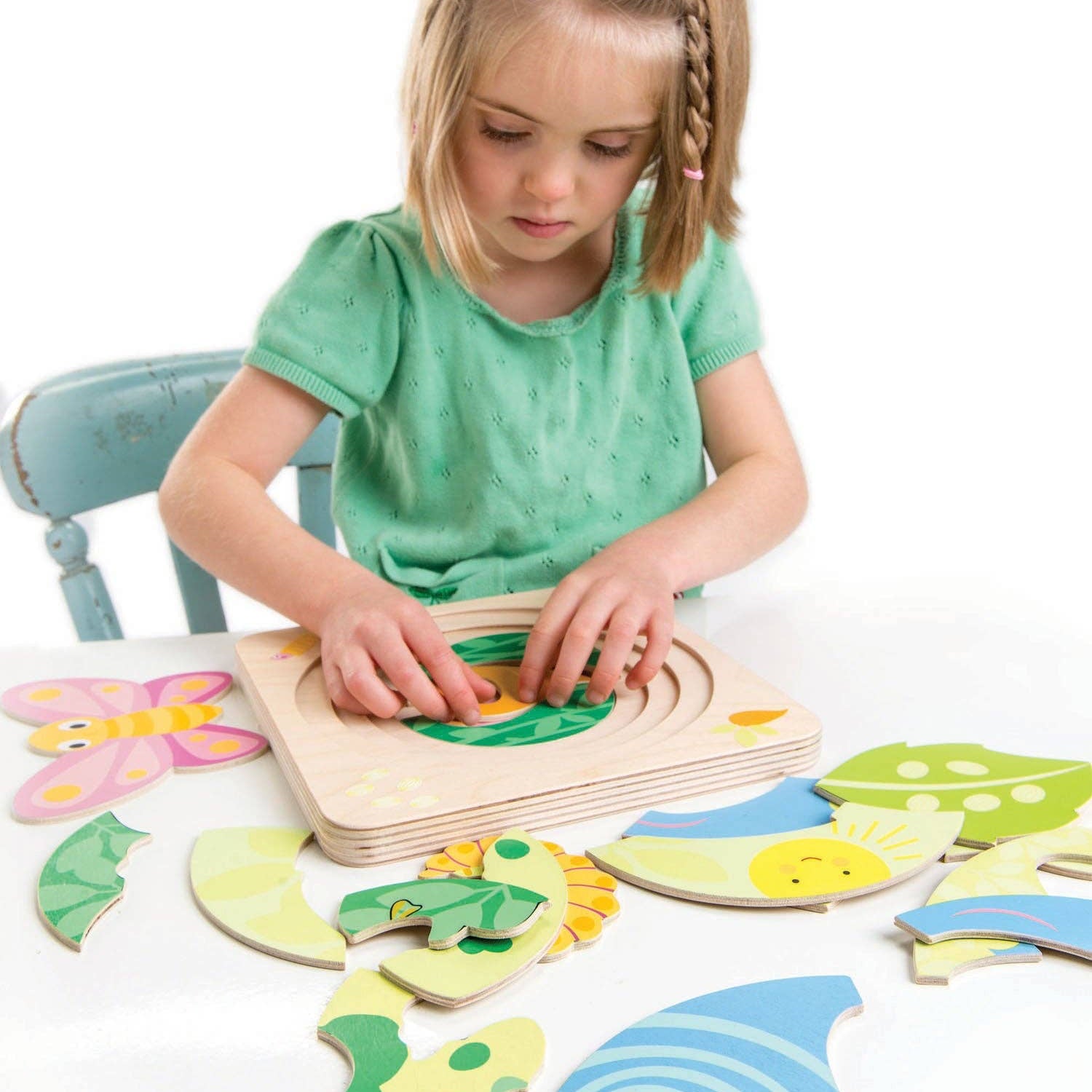 Wooden children's puzzle with a butterfly design on a blue background