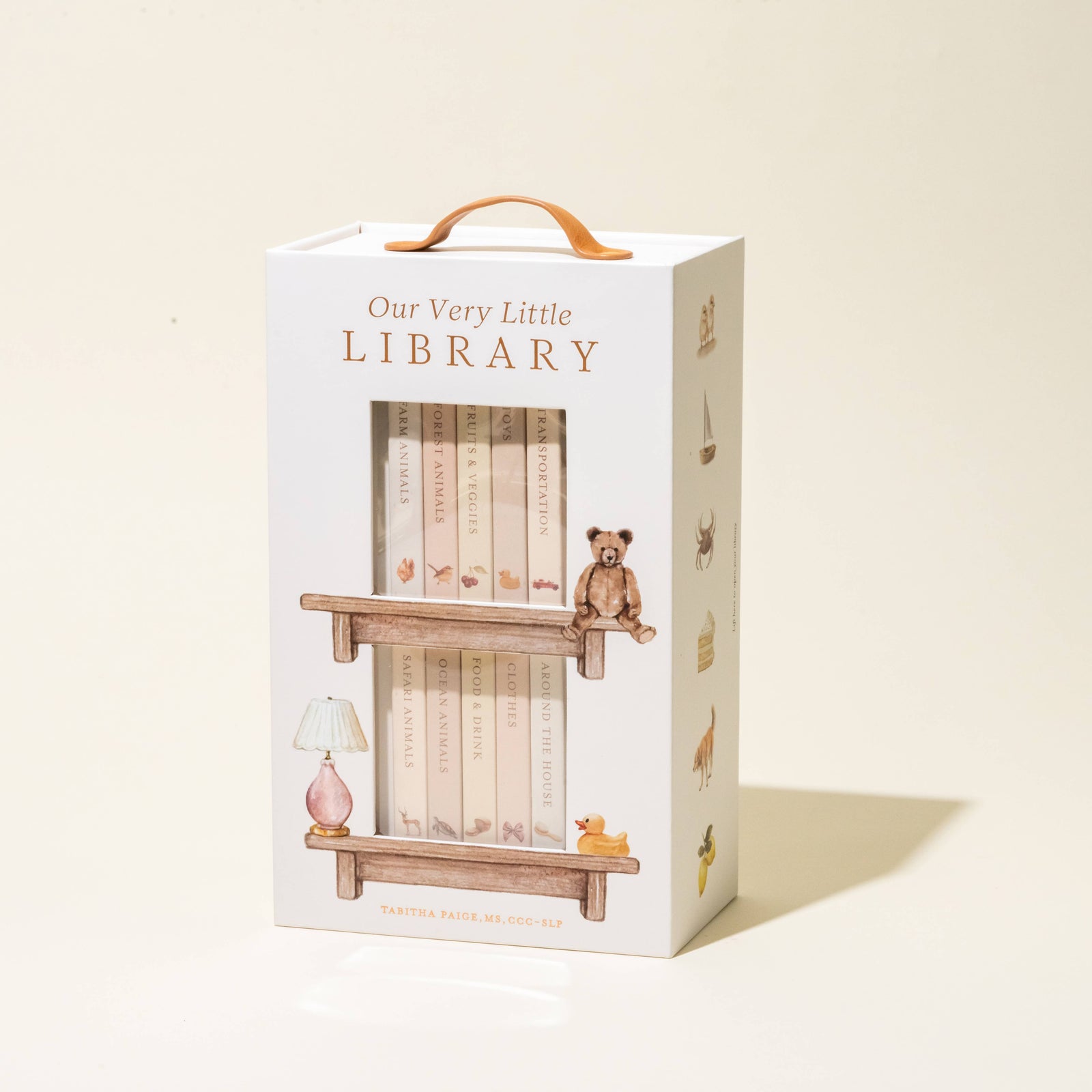 Box packaging for 'Our Very Little Library' with illustrations of books and a teddy bear.