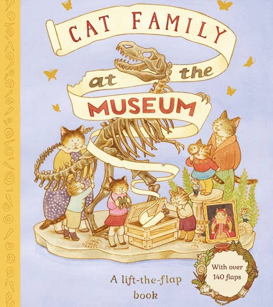 Front cover of the children's book 'Cat Family at the Museum' by Lucy Brownridge, illustrated by Eunyoung Seo. The cover features a lavender background with a gold spine stripe on the left, whimsical illustrations of cat characters around a dinosaur skeleton, and text indicating it is a lift-the-flap book with over 140 flaps.