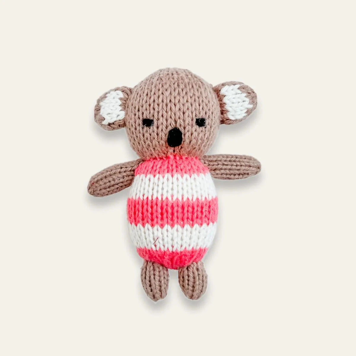 A knitted koala toy with a brown body, white inner ears, and a pink and white striped sweater, centered on a light beige background.