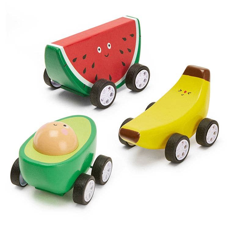 Wooden toy cars shaped like a watermelon, banana, and avocado on a white background