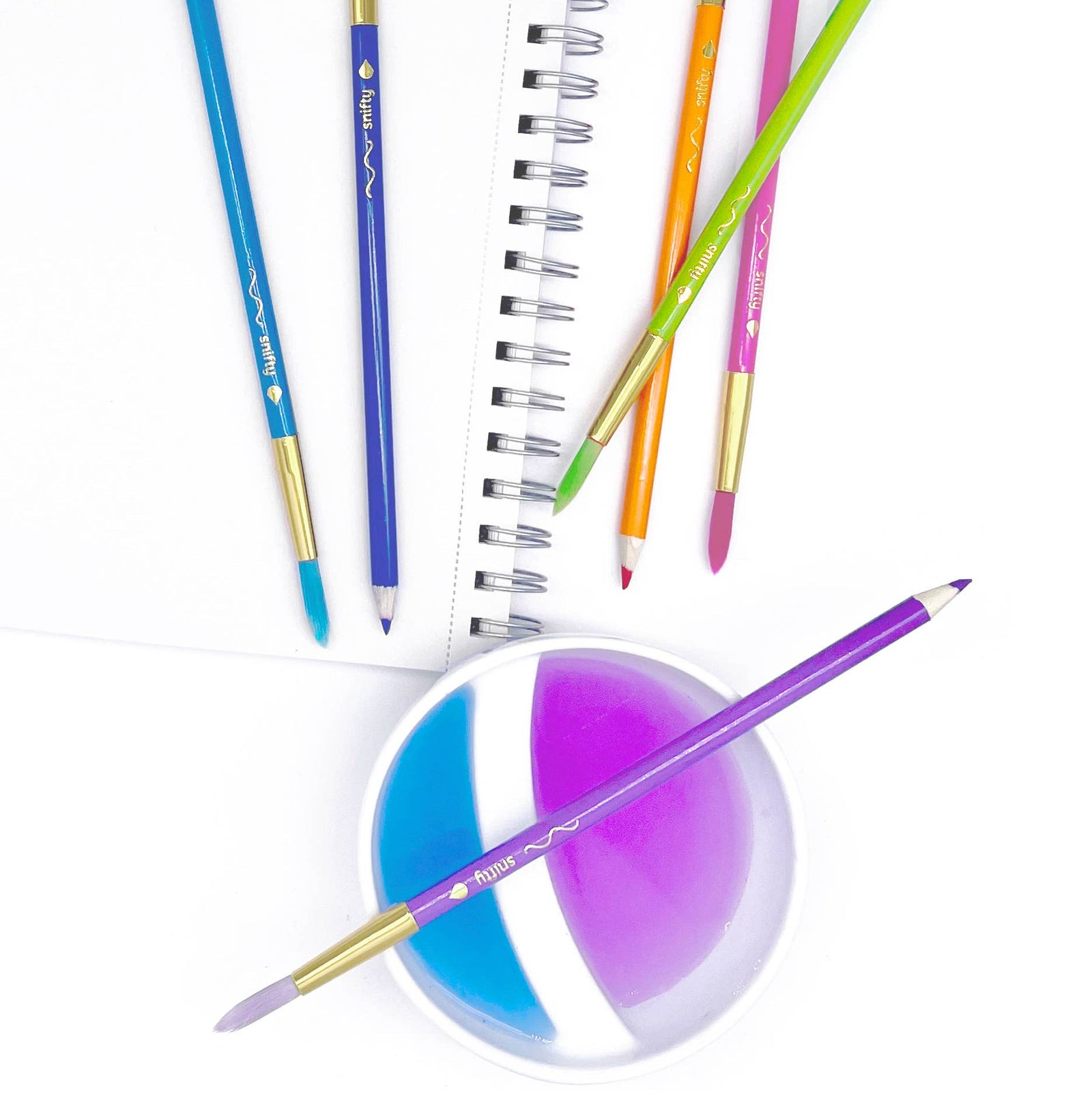 Set of 12 ColorBrush watercolor pencils and paintbrushes in pastel colors on a white background.