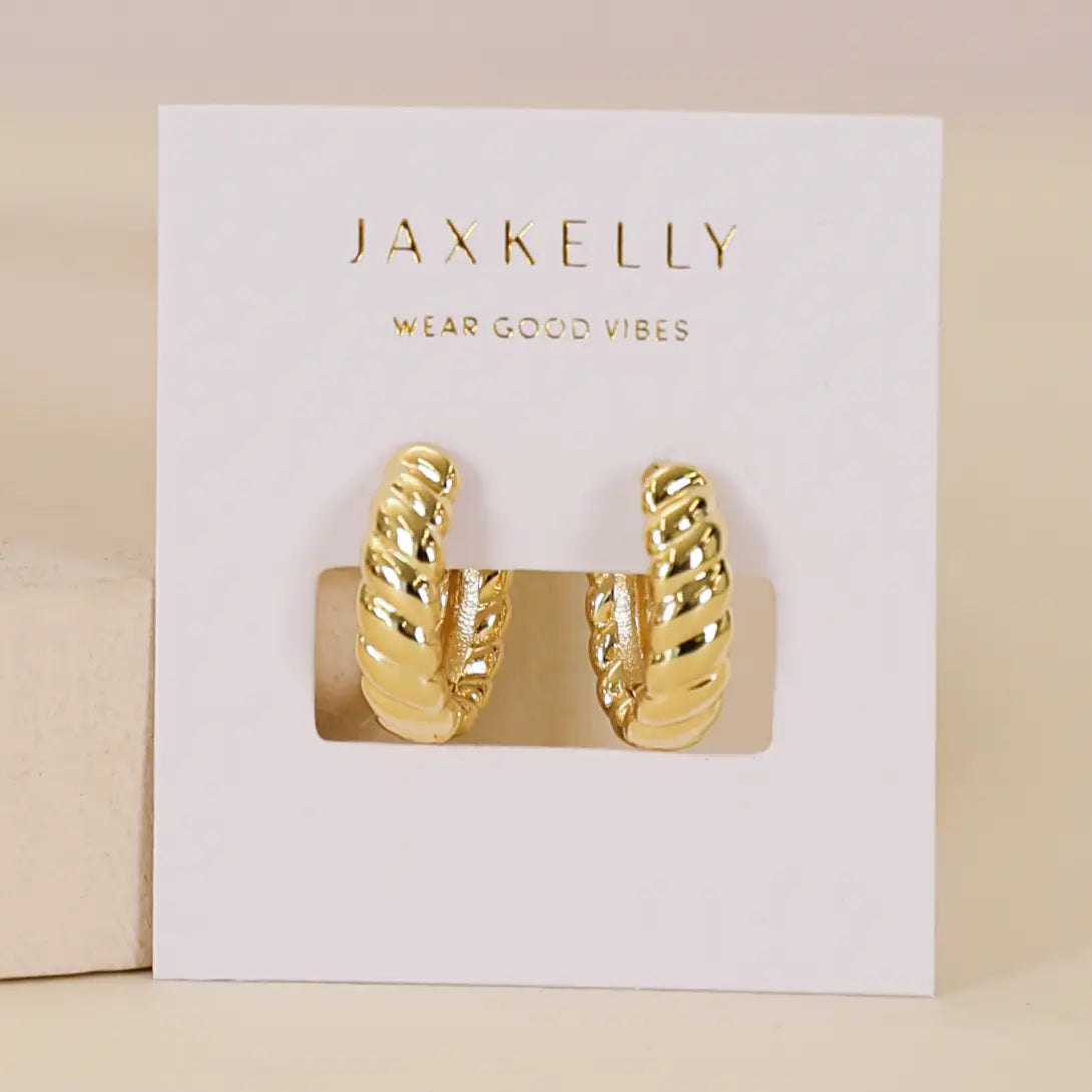 Gold hoop earrings on a Jaxkelly branded card with a beige background