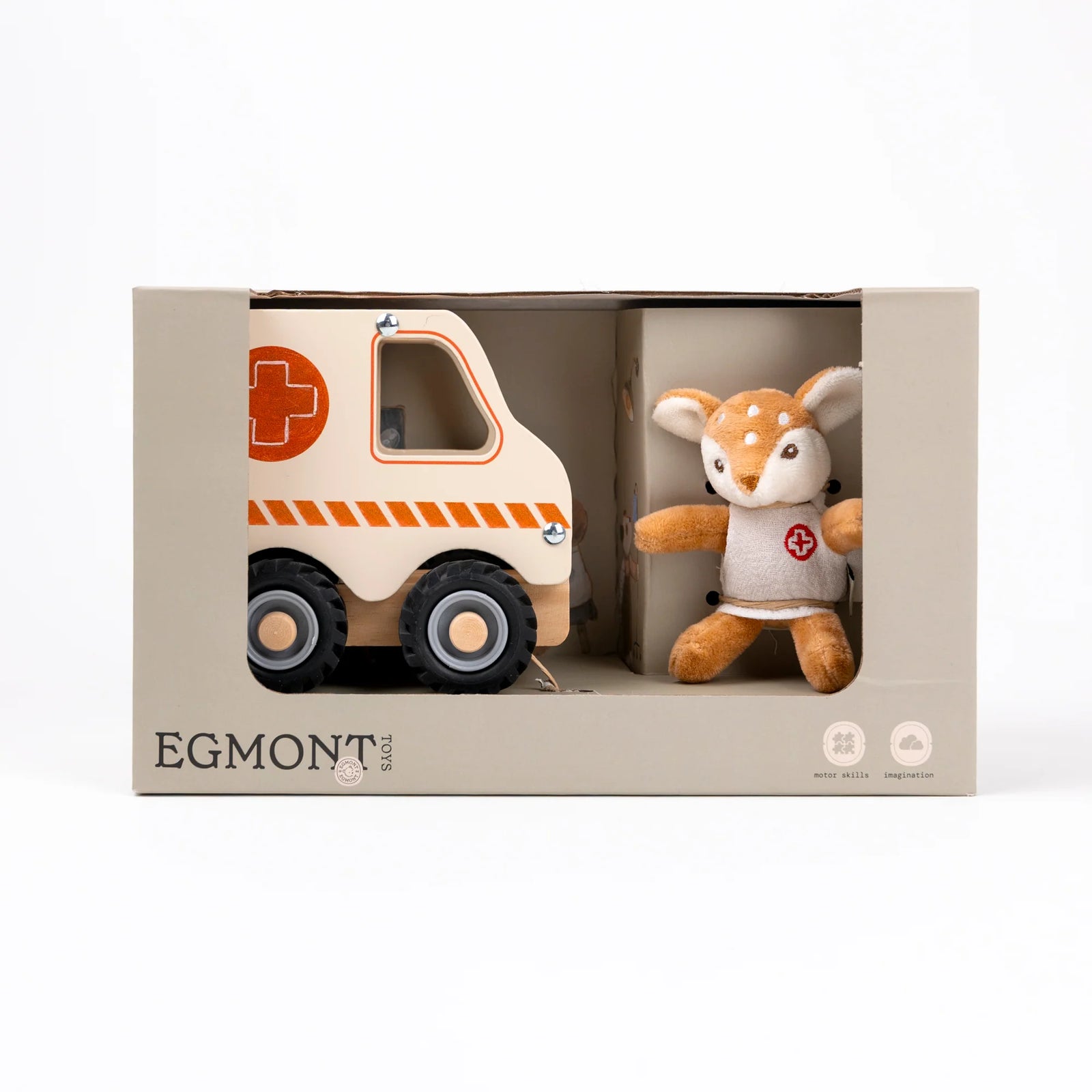 A wooden toy ambulance with a cream-colored body, orange accents including a cross symbol and hazard stripes, black wheels, and a plush animal inside the driver's seat, shown on a white background.