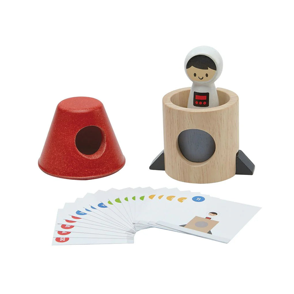 Wooden toy set with a red cone, wooden tube, and cards on a white background