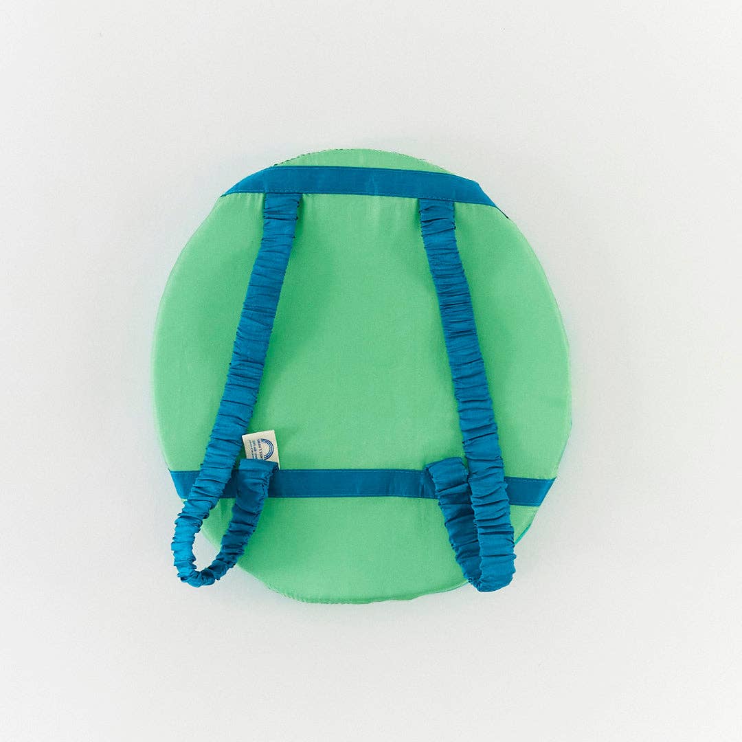 A green circular custume  with blue elastic straps and bands, photographed from above on a plain white background.