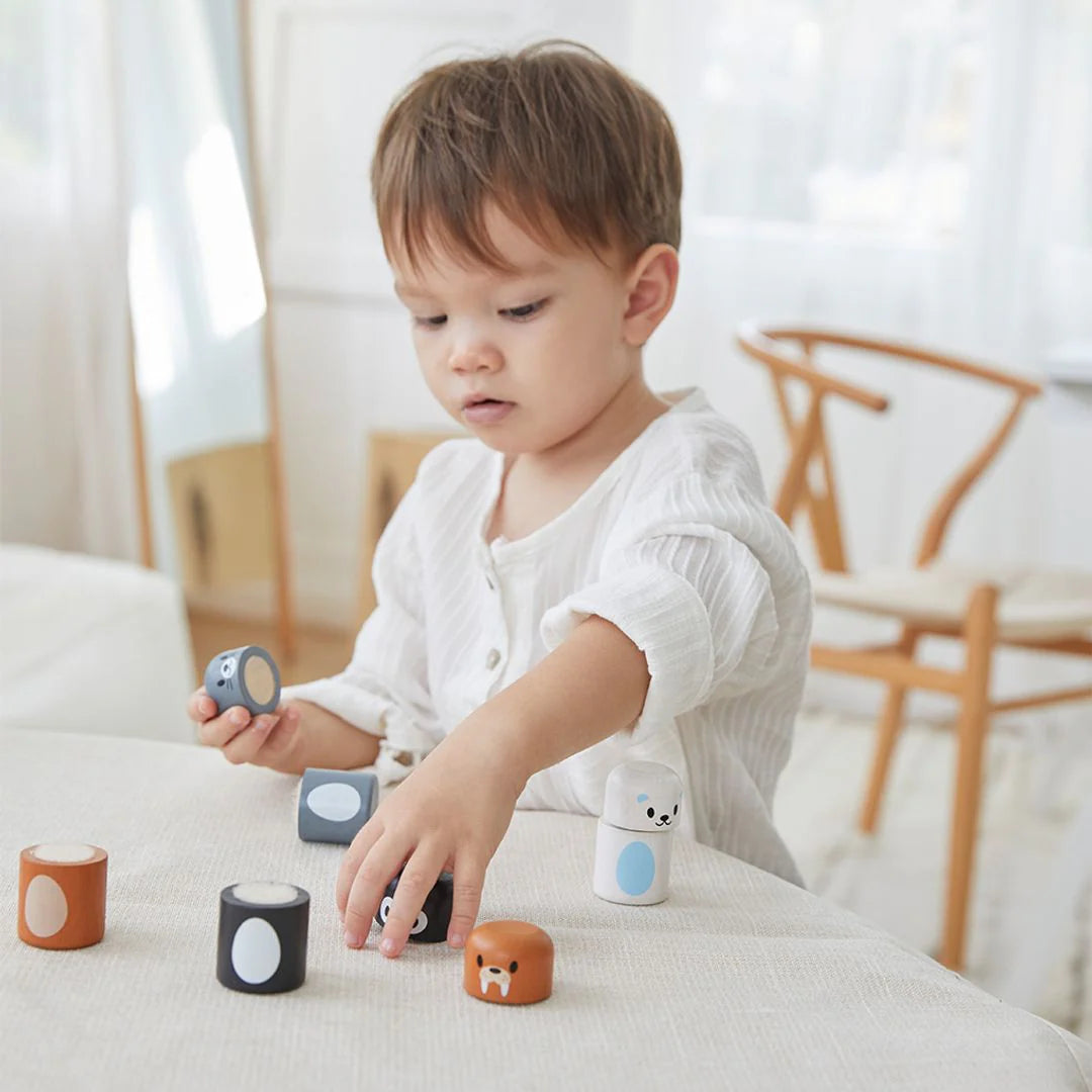 Child playing with colorful blocks on a light surface