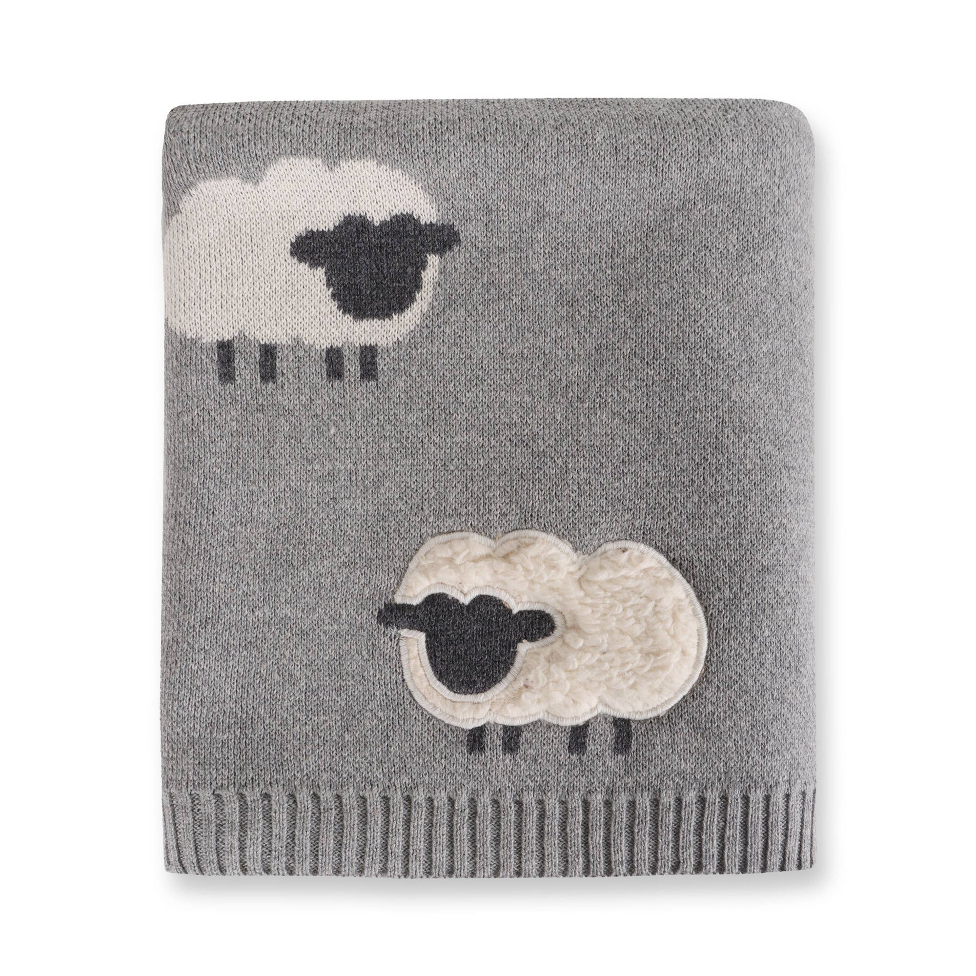 Gray knitted blanket with sheep designs on a white background