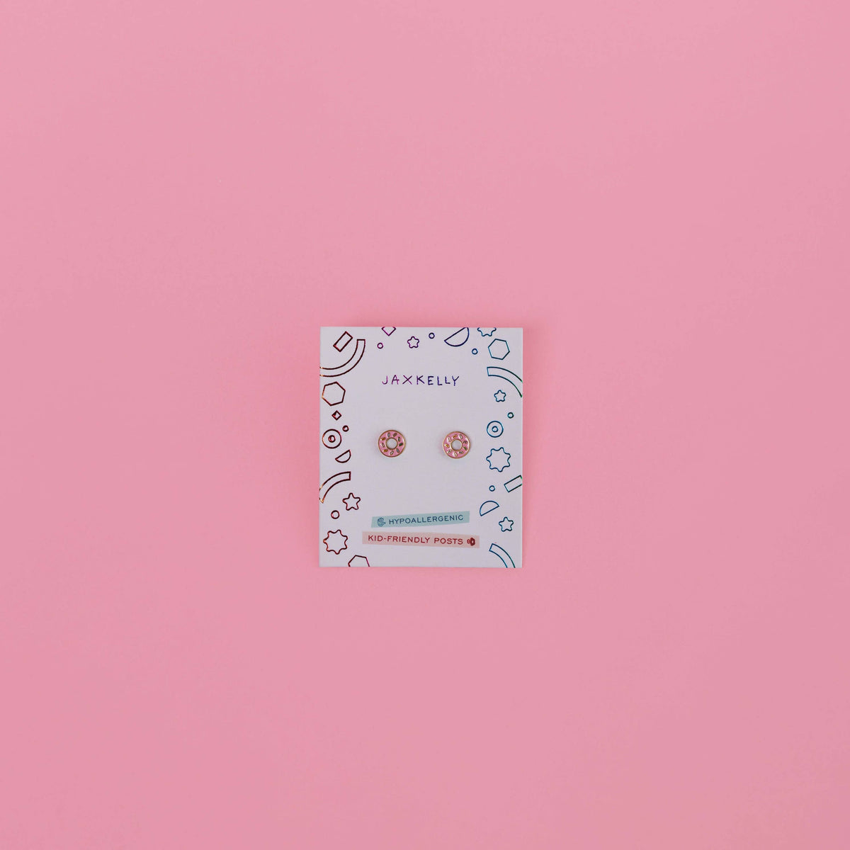Jewelry card with earrings on a pink background