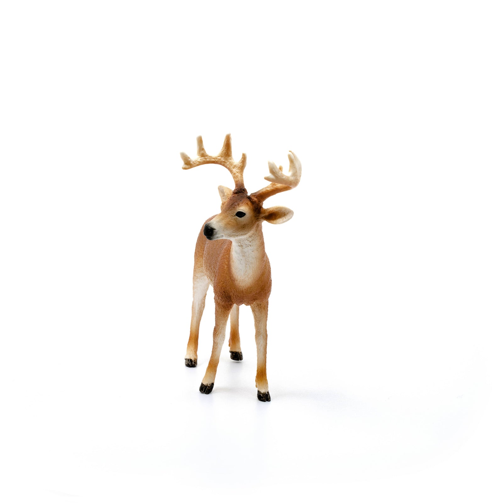 Deer figurine with large antlers on a white background