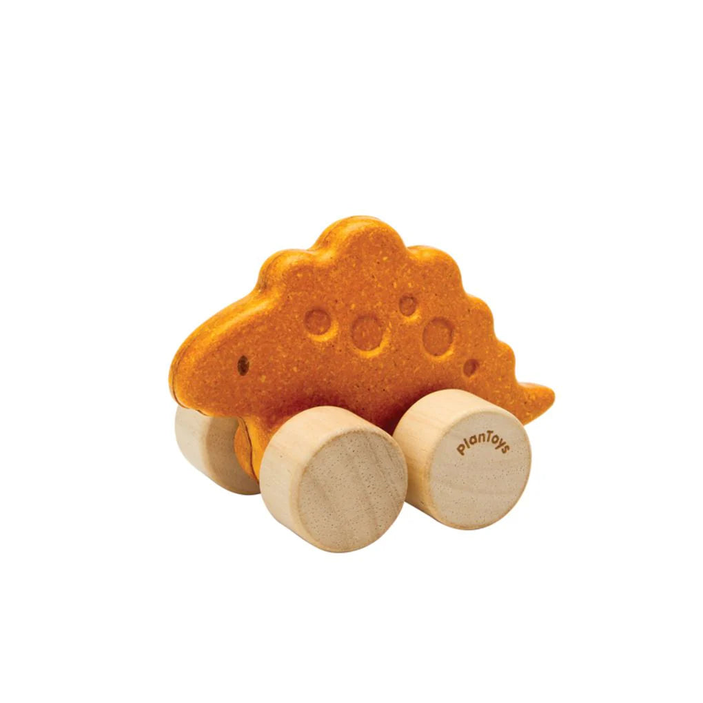 Wooden toy dinosaur with wheels on a white background