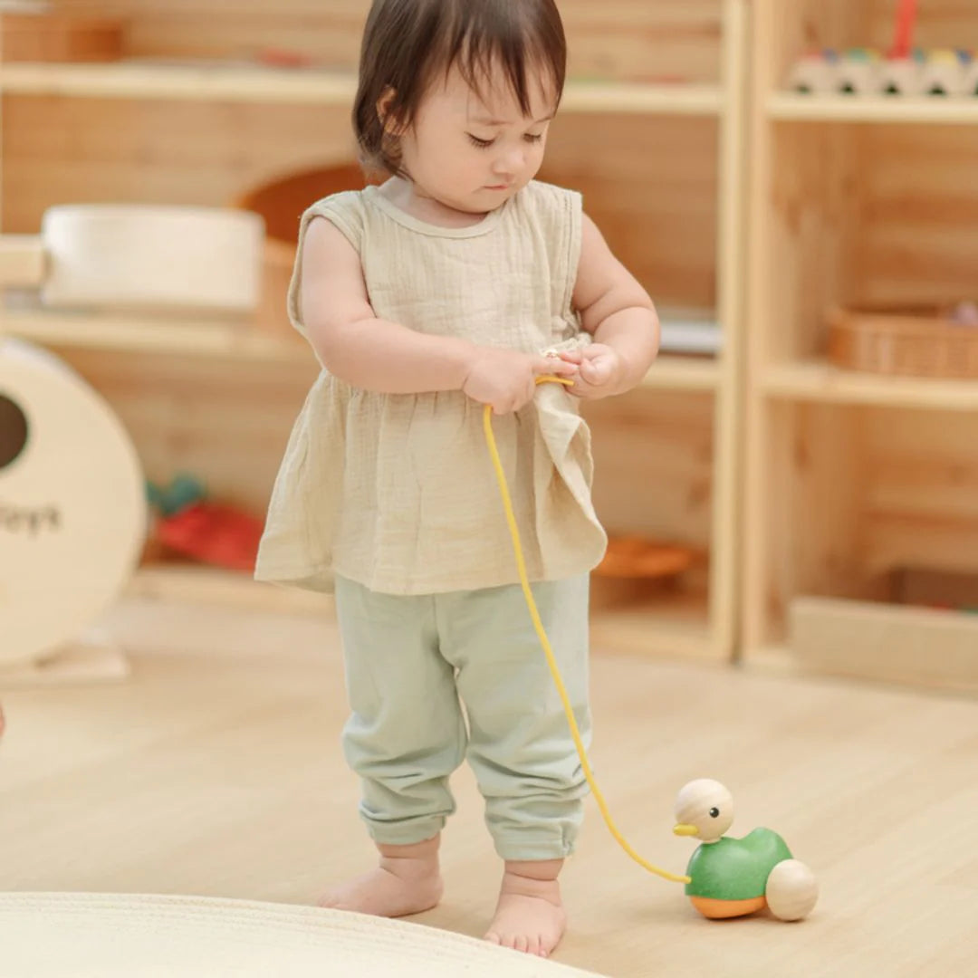 Child playing with a toy duck in a Montessori classroom