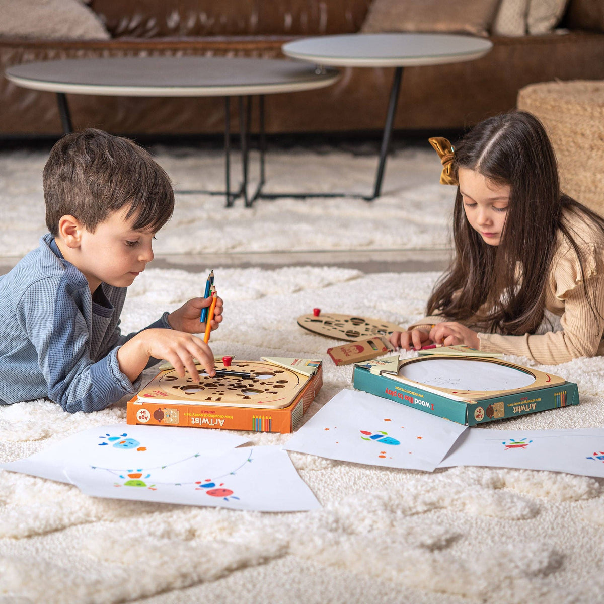 Two children playing with art activity on a carpeted floor.